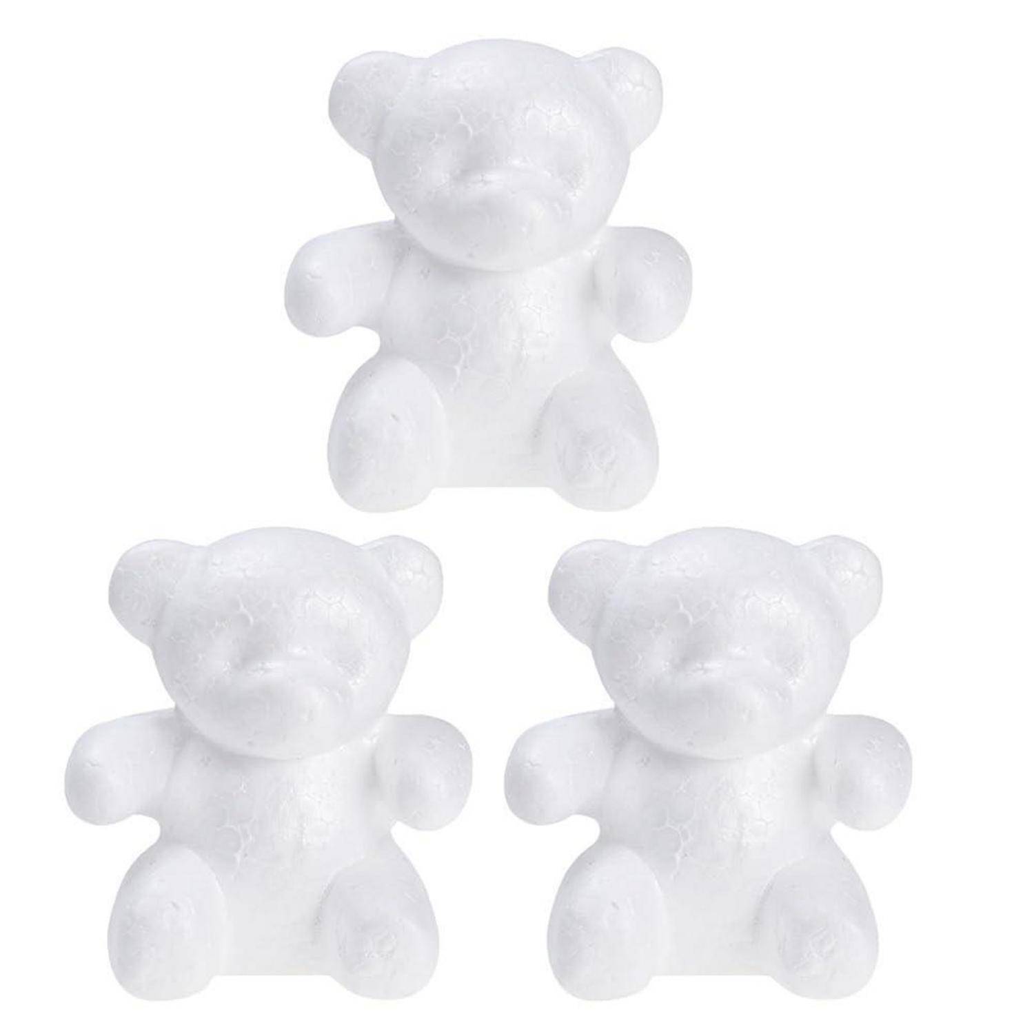 Drei kleine weiße Teddybär-Figuren in einem Dreieck auf einem schlichten weißen Hintergrund angeordnet.