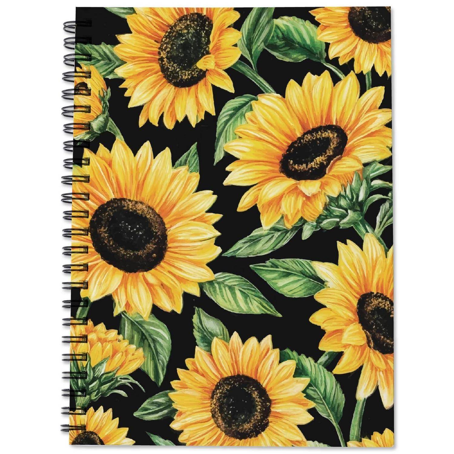 Ein spiralgebundenes Notizbuch mit schwarzem Umschlag, verziert mit großen gelben Sonnenblumen und grünen Blättern.