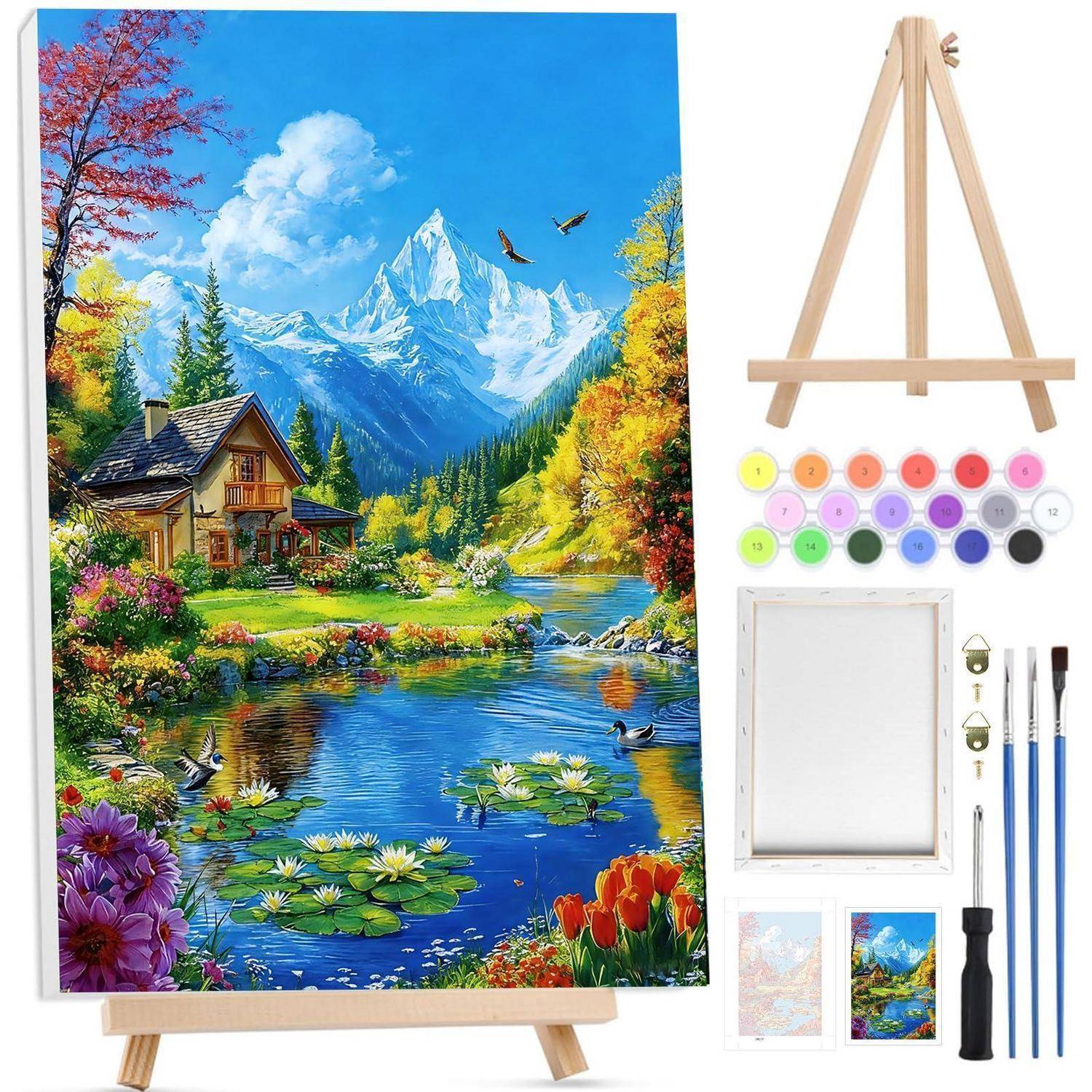 Malbuch-Kunstset mit einer Staffelei und Leinwand mit einer farbenfrohen Bergseenlandschaft, sowie Farben, Pinseln und Rahmenzubehör.