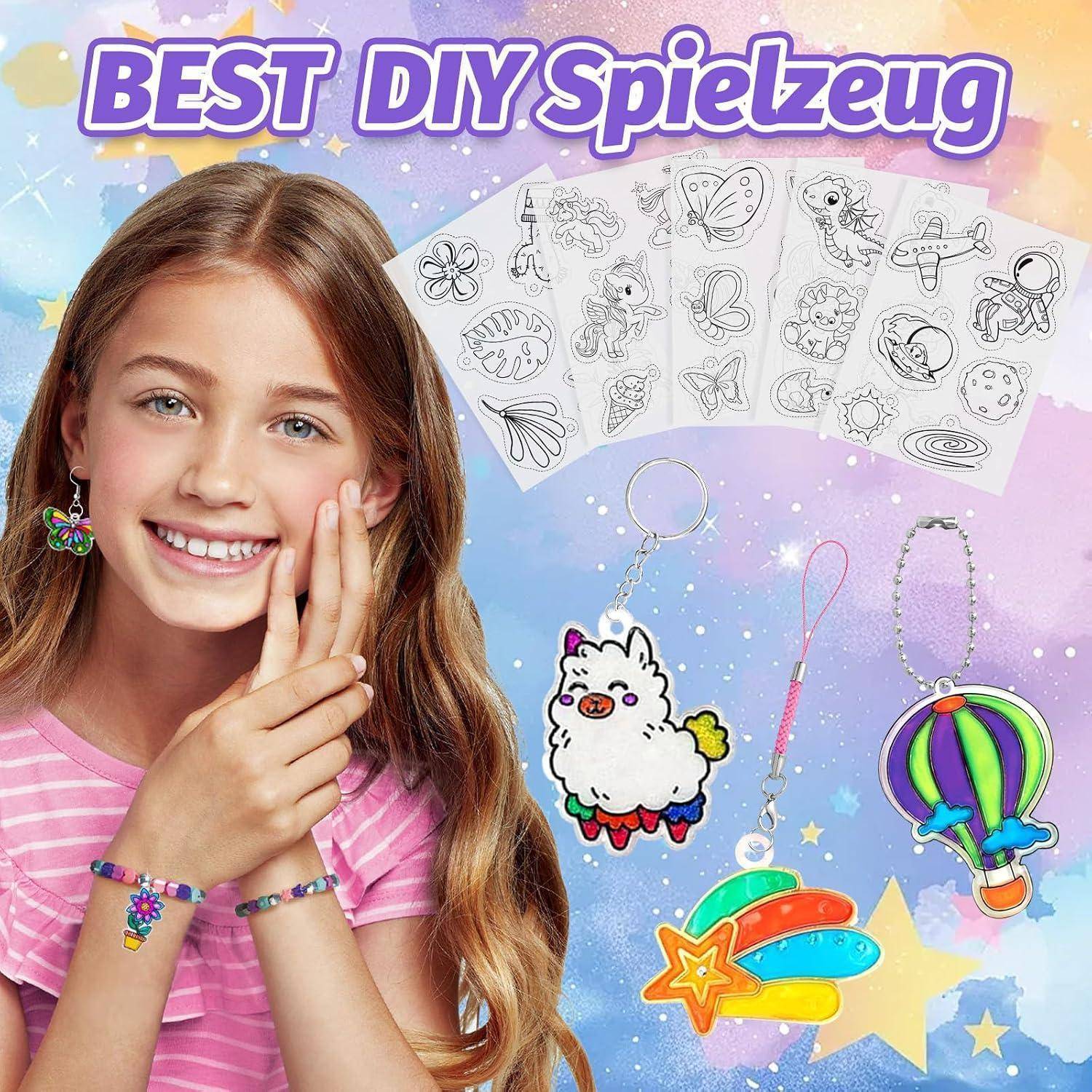 Mädchen lächelnd neben DIY-Spielzeug-Bastelset mit Aufkleber-Blättern und farbenfrohen Schlüsselanhänger-Charms, mit dem Titel 