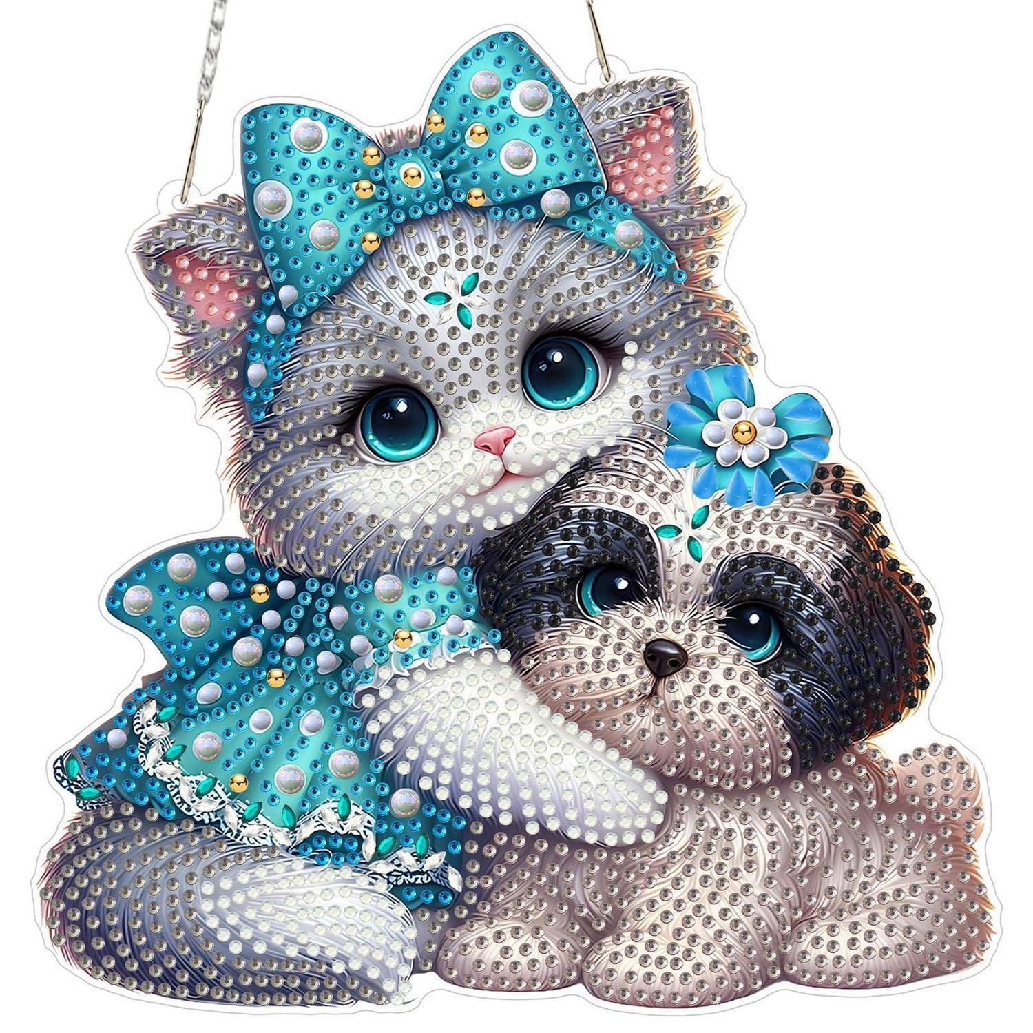 Funkelndes Schmuckkatzen- und Welpenornament mit blauen Schleifen, das sich auf weißem Hintergrund aneinander kuschelt.