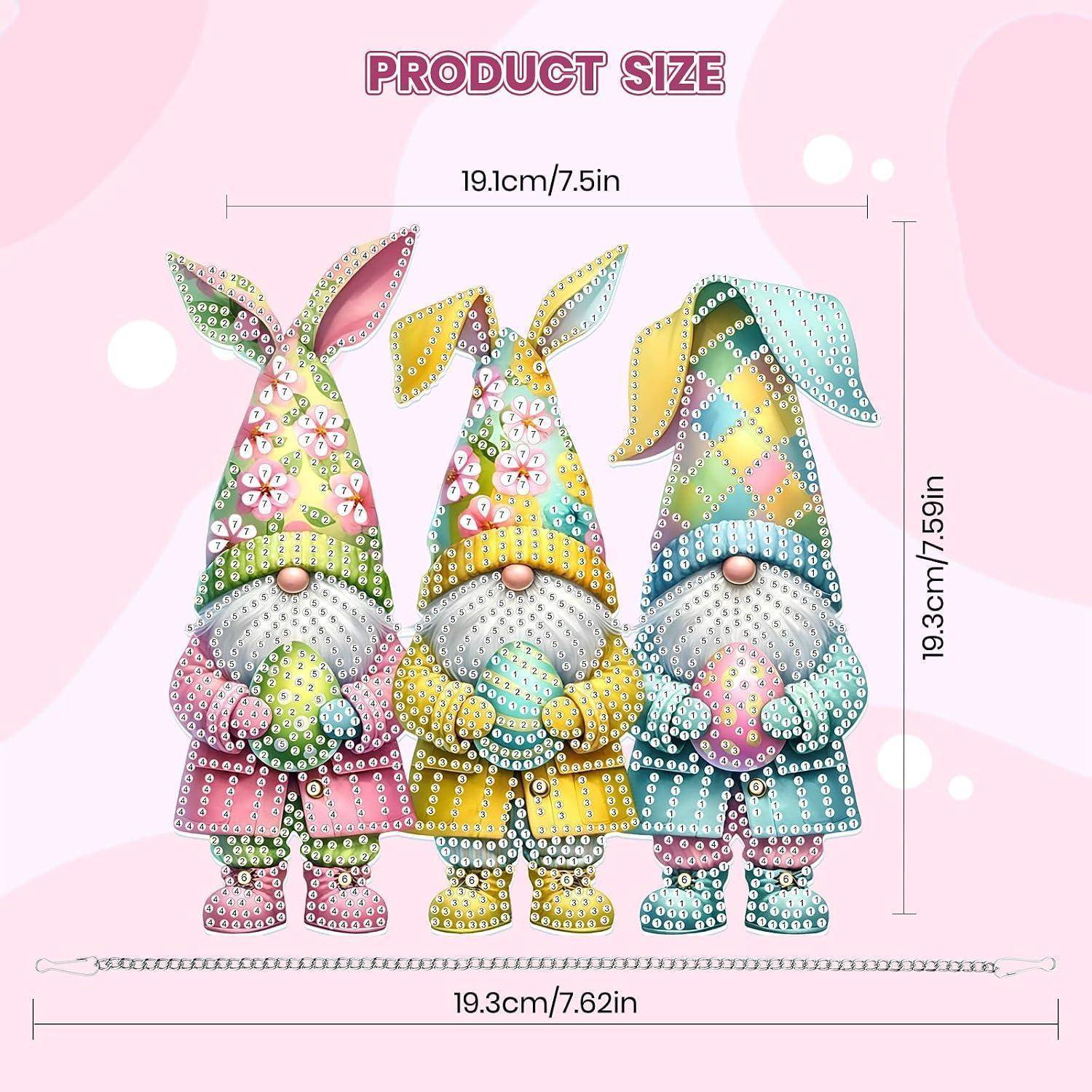 Das Größendiagramm des Produkts zeigt drei bunte Gnomund-Figuren, die jeweils etwa 19,3 cm groß und 19,1 cm breit sind, mit einer Sockelbasis von 19,3 cm Breite.