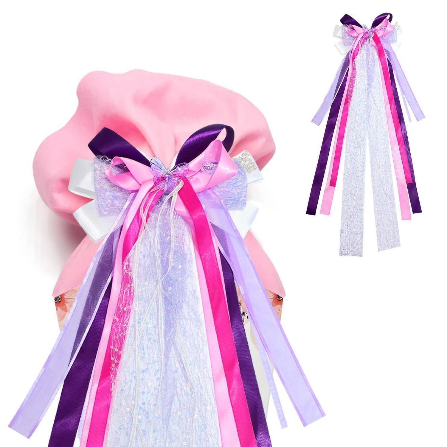Rosa Geschenktasche mit einer großen dekorativen Schleife und langen violetten, rosa und weißen Bändern, zusammen mit einer kleineren passenden Bandverzierung gezeigt.