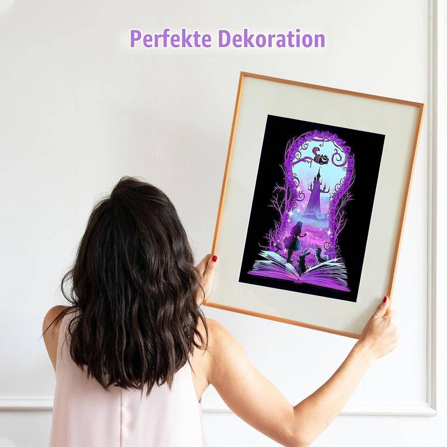 Eine Frau hängt eine gerahmte Fantasy-Illustration an eine Wand unter dem Text „Perfekte Dekoration