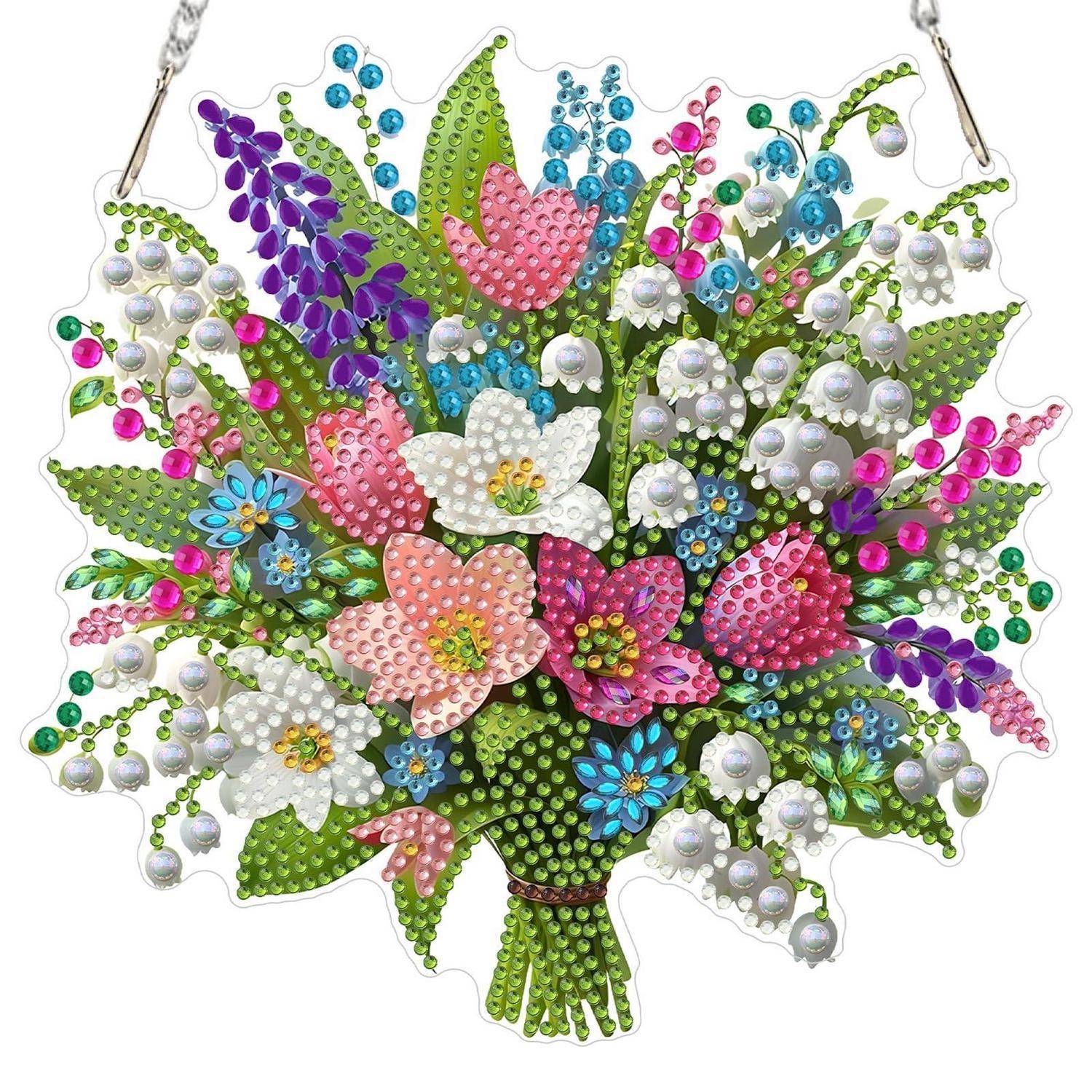 Dekorative Wandbehang aus Schmucksteinen mit farbenfrohen Blumen, grünen Blättern und perlmuttartigen Akzenten auf weißem Hintergrund.