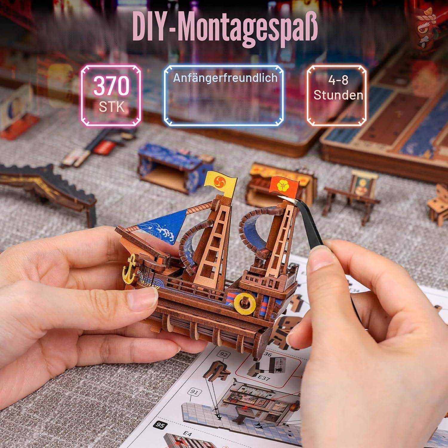 Hände montieren ein Miniatur-Piratenschiffmodell; der Text sagt 'DIY-Montagespaß', '370 STK', 'Anfängerfreundlich' und '4-8 Stunden'.