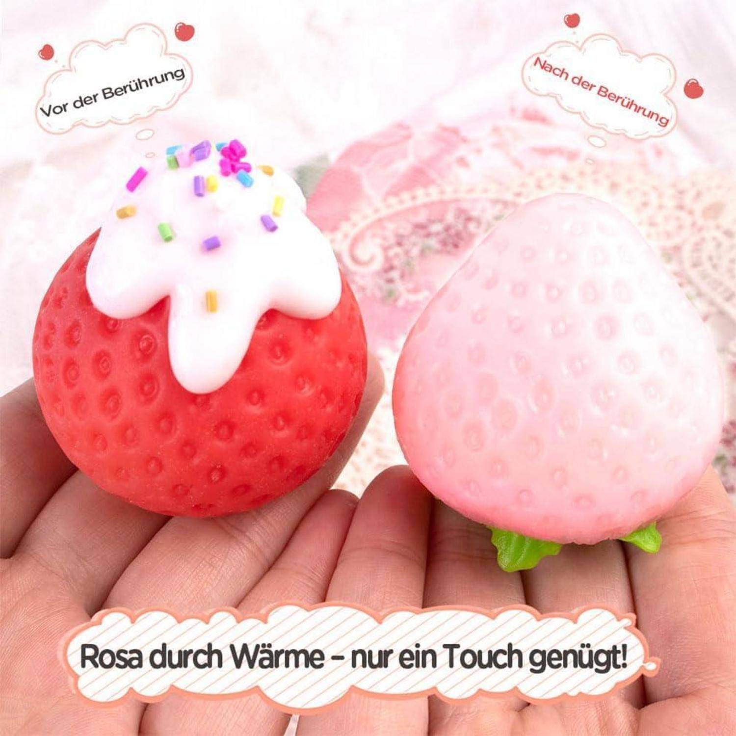 Farbwechselndes Erdbeer-Squishy wechselt von Rot mit weißer Glasur zu hellem Rosa, wenn es berührt oder erwärmt wird; deutscher Text sagt „Rosa durch Wärme – nur ein Touch genügt!"