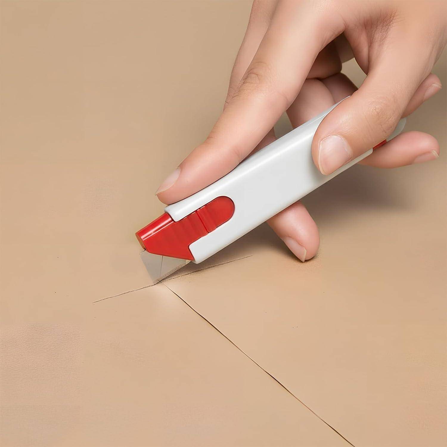 Eine Hand benutzt einen Kartonmesser, um ein versiegeltes Paket aus Pappe auf einer beigen Oberfläche zu öffnen.