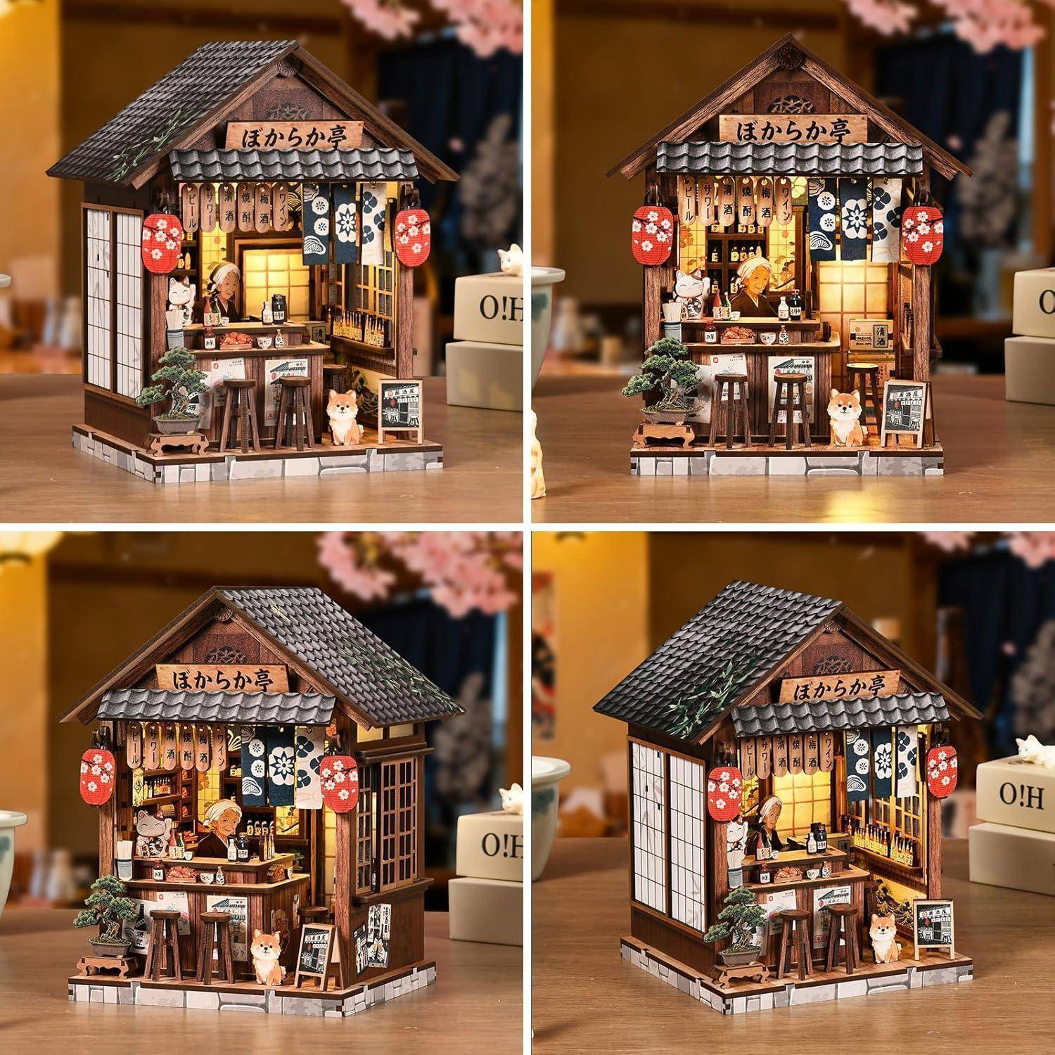 Vier Ansichten eines japanischen Miniatur-Schaufenster-Dioramas mit Ziegeldach, Laternen, hängenden Schildern, Theke und kleinen Katzenfiguren zur Ausstellung.