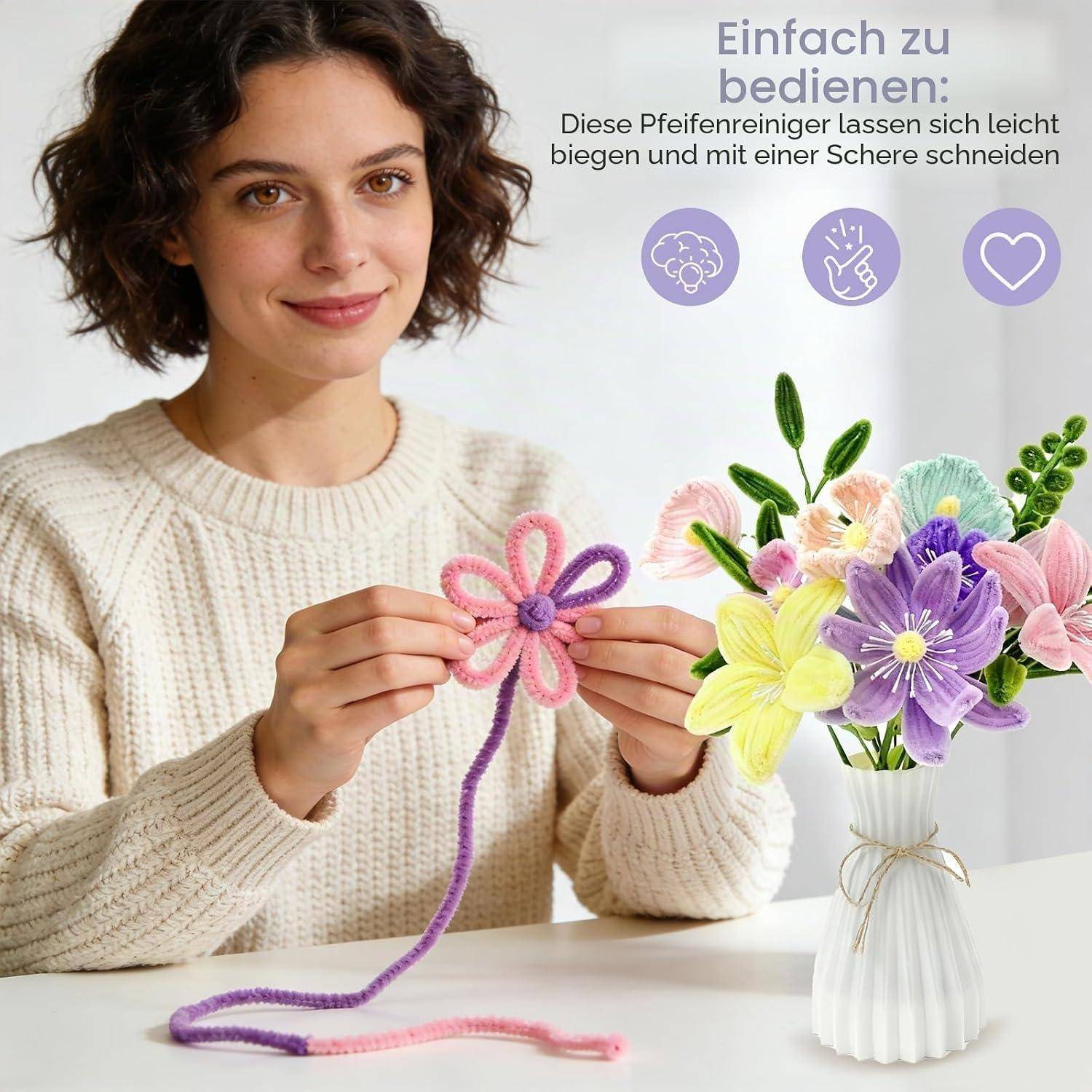 Eine Frau zeigt das Biegen eines Pfeifenreinigers zu einer Blume; der Text besagt: „Einfach zu bedienen: Diese Pfeifenreiniger lassen sich leicht biegen und mit einer Schere schneiden