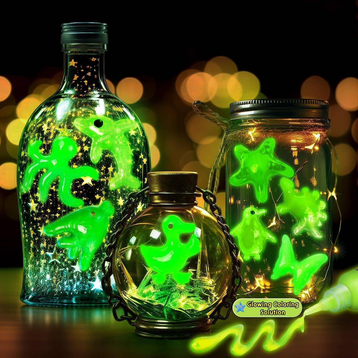 Drei leuchtend grüne Halloween-Gläser und eine Flasche gefüllt mit neongelben Monster- und Geisterformen, beleuchtet vor einem dunklen Bokeh-Hintergrund.