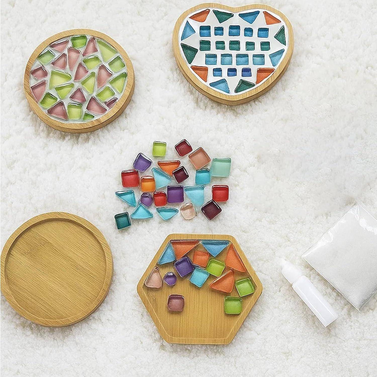 Bunte Harzstücke in verschiedenen Farben in Bambusfächern und lose in der Mitte angeordnet, zeigen verschiedene Formen und Größen für ein Kunst- oder Mosaikset.