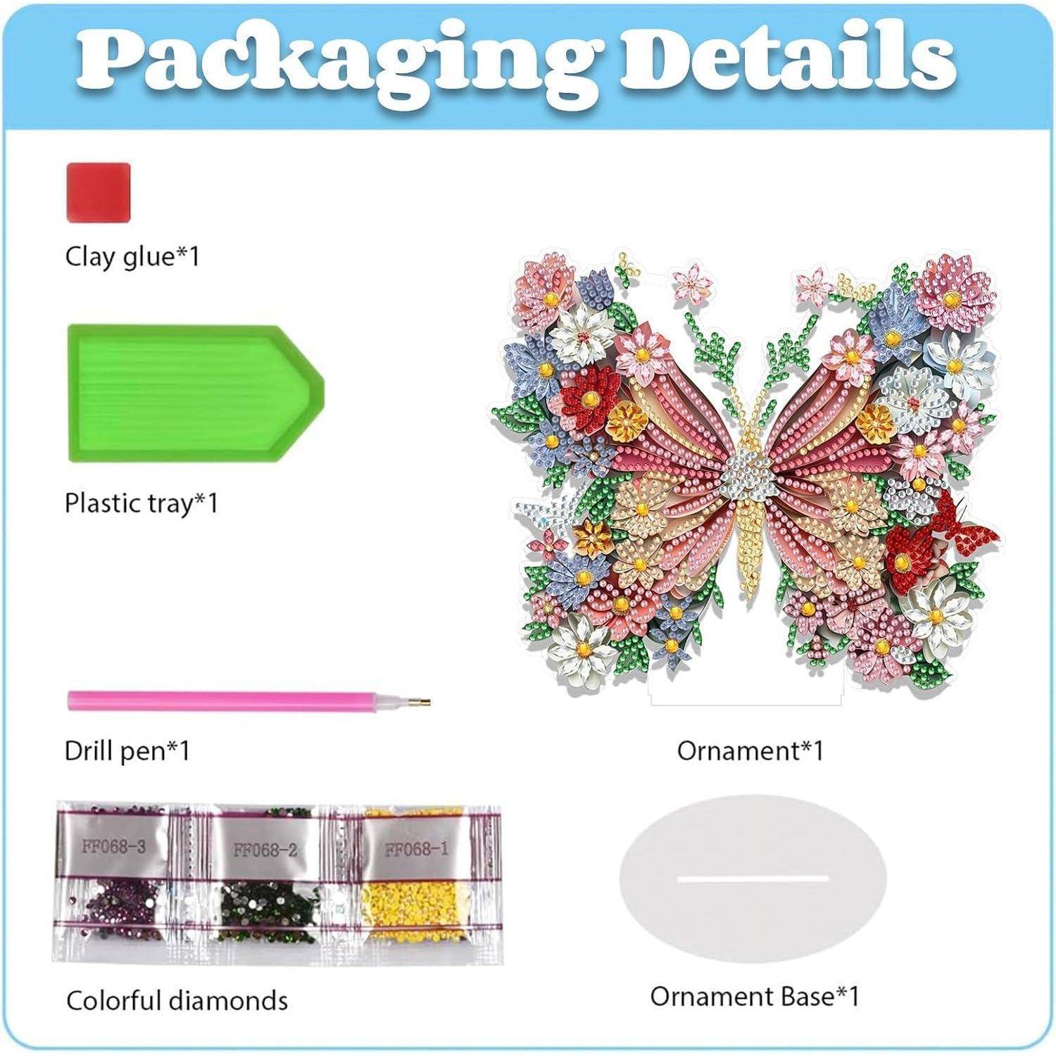 Verpackungsdetails für ein Schmetterlings-Ornament-Set: Ton-Kleber, Kunststoff-Tablett, Bohrerstift, farbige Diamanten und eine Ornament-Basis.
