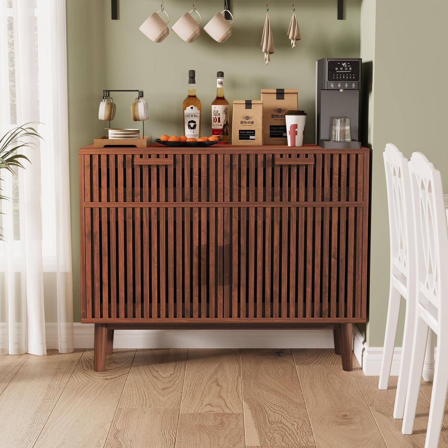 Modernes Holzbarschrank mit Lamellentüren, beladen mit Flaschen, Tassen und einer Kaffeemaschine in einem Essbereich mit weißen Stühlen.