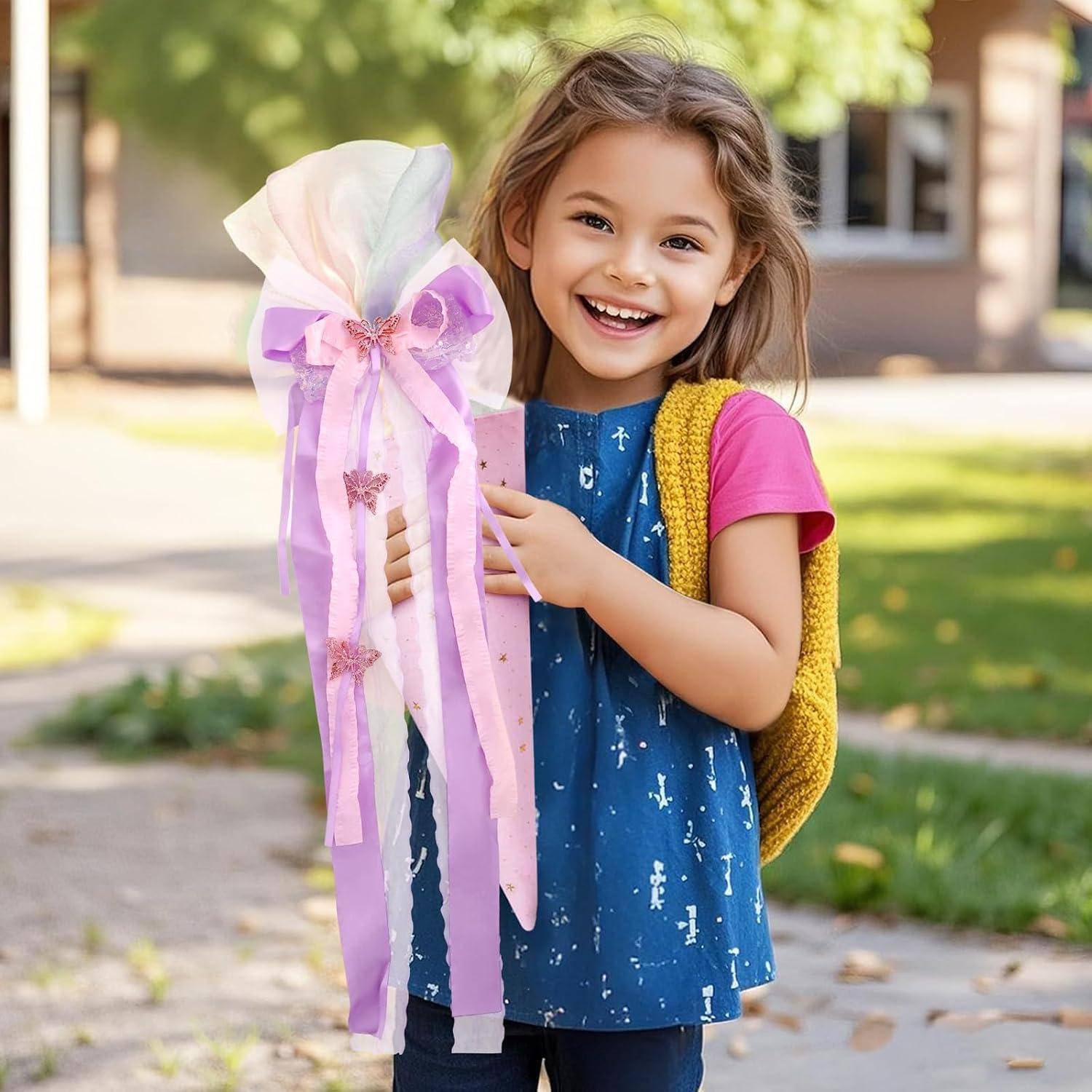 Lächelndes junges Mädchen im Freien, das eine große Geschenktasche oder ein Bastelprojekt mit rosa und lila Schleifen hält, mit einem Rucksack auf der Schulter.