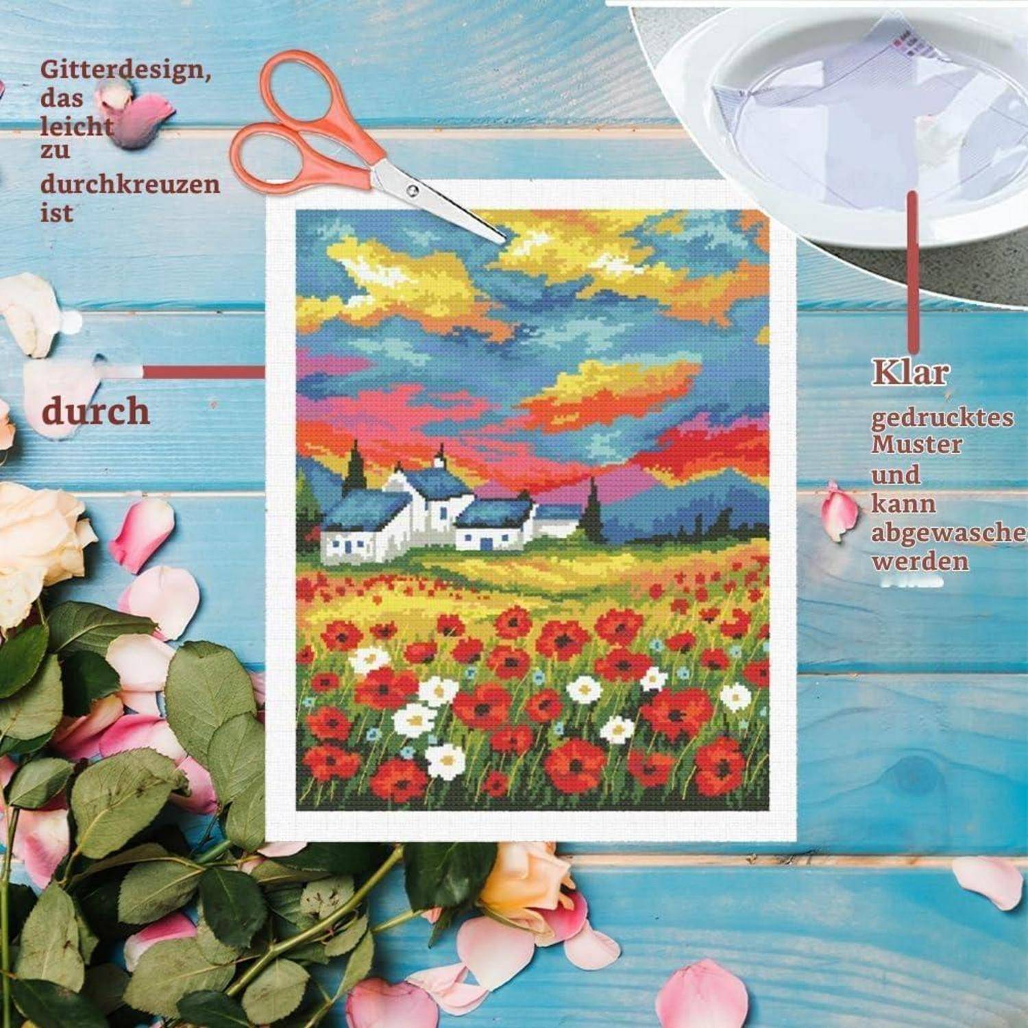 Handwerkszene mit Stickerei auf klarem bedrucktem Muster: eine Landschaft mit Häusern, Blumen und einem bunten Sonnenuntergang, umgeben von Scheren und Rosen.