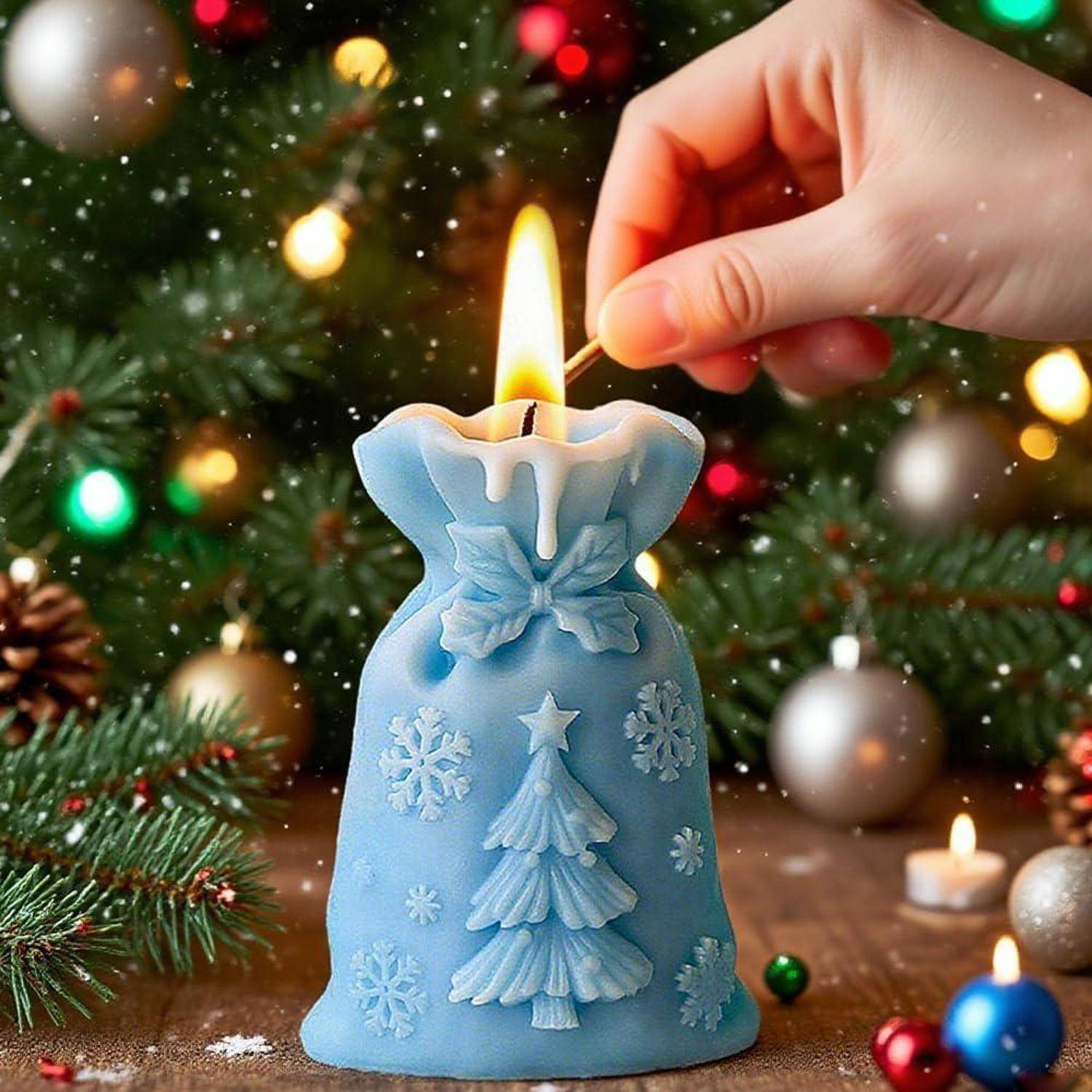 Eine Hand zündet eine blaue Weihnachtskerze mit einem brennenden Streichholz vor einem geschmückten Baum und Weihnachtskugeln an.