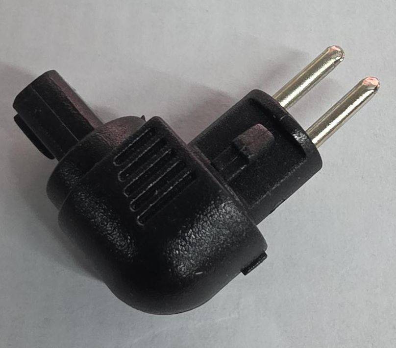 Schwarzer rechtwinkliger zweipoliger Elektrostecker-Adapter auf grauem Hintergrund.