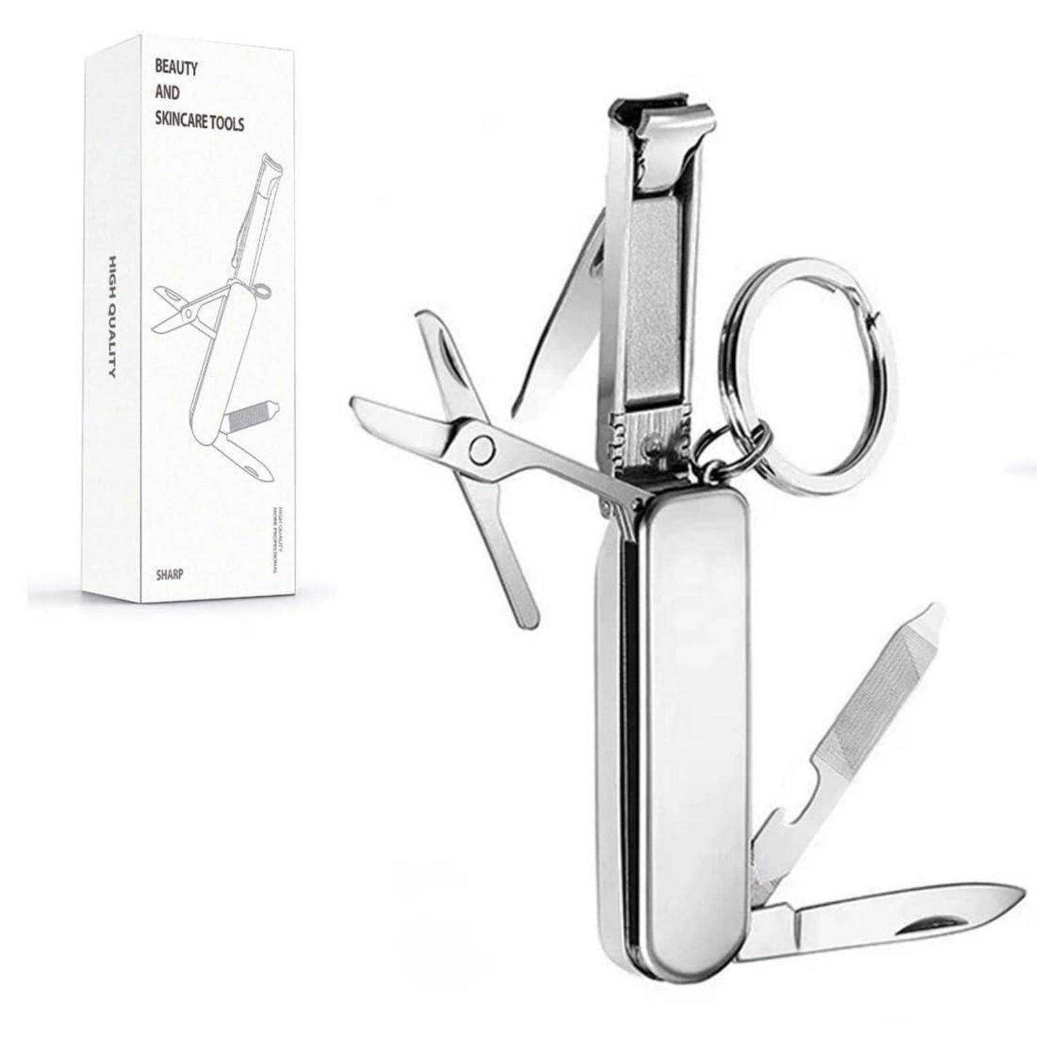 Silbernes Multifunktions-Pflegeset mit Nagelschere, Schere, Feile und Schlüsselring neben seiner Verpackung „Beauty and Skincare Tools