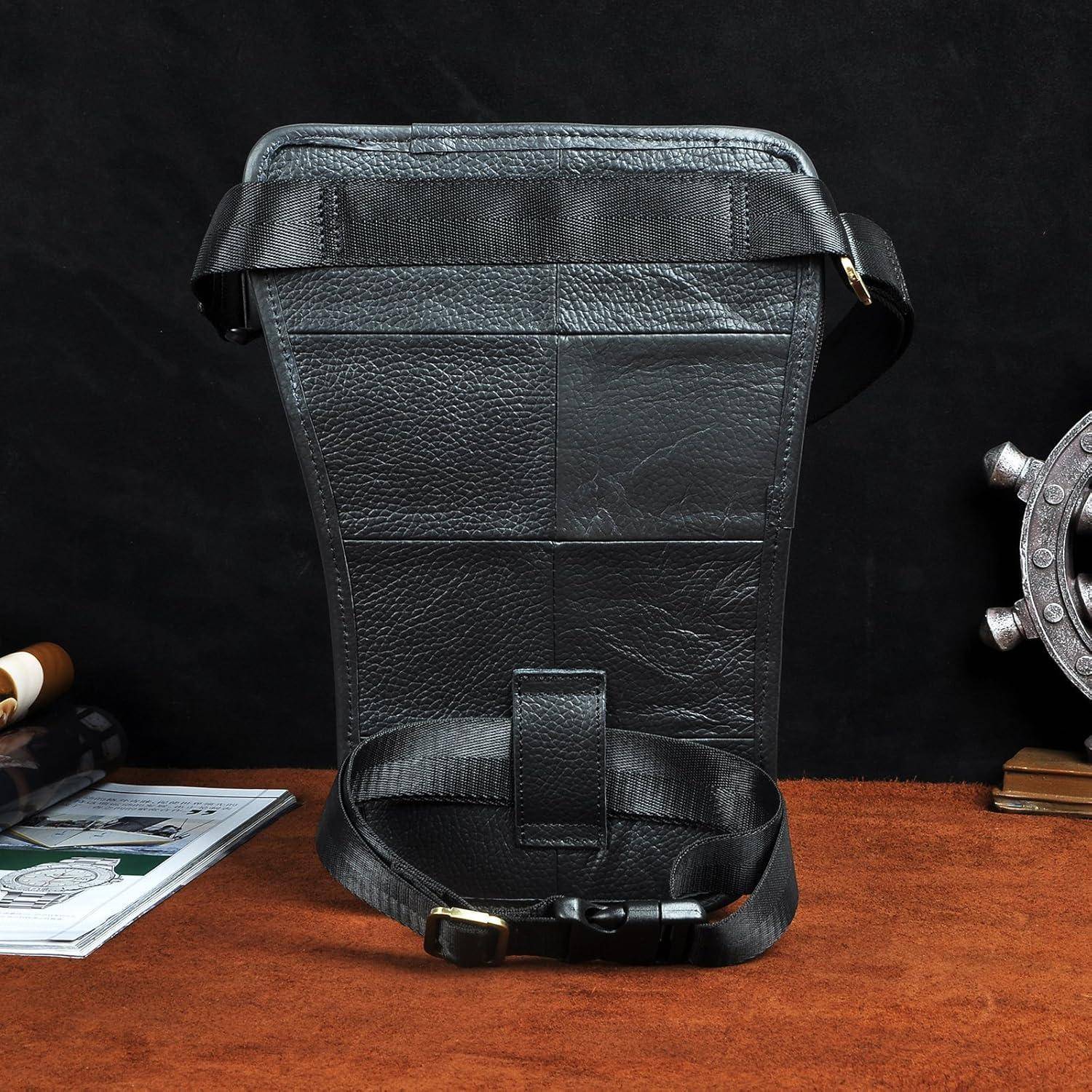 Schwarze Lederholster-Gürteltasche oder Brusttasche mit verstellbarem Riemen aufrecht auf einer braunen Oberfläche vor einem dunklen Hintergrund angezeigt.