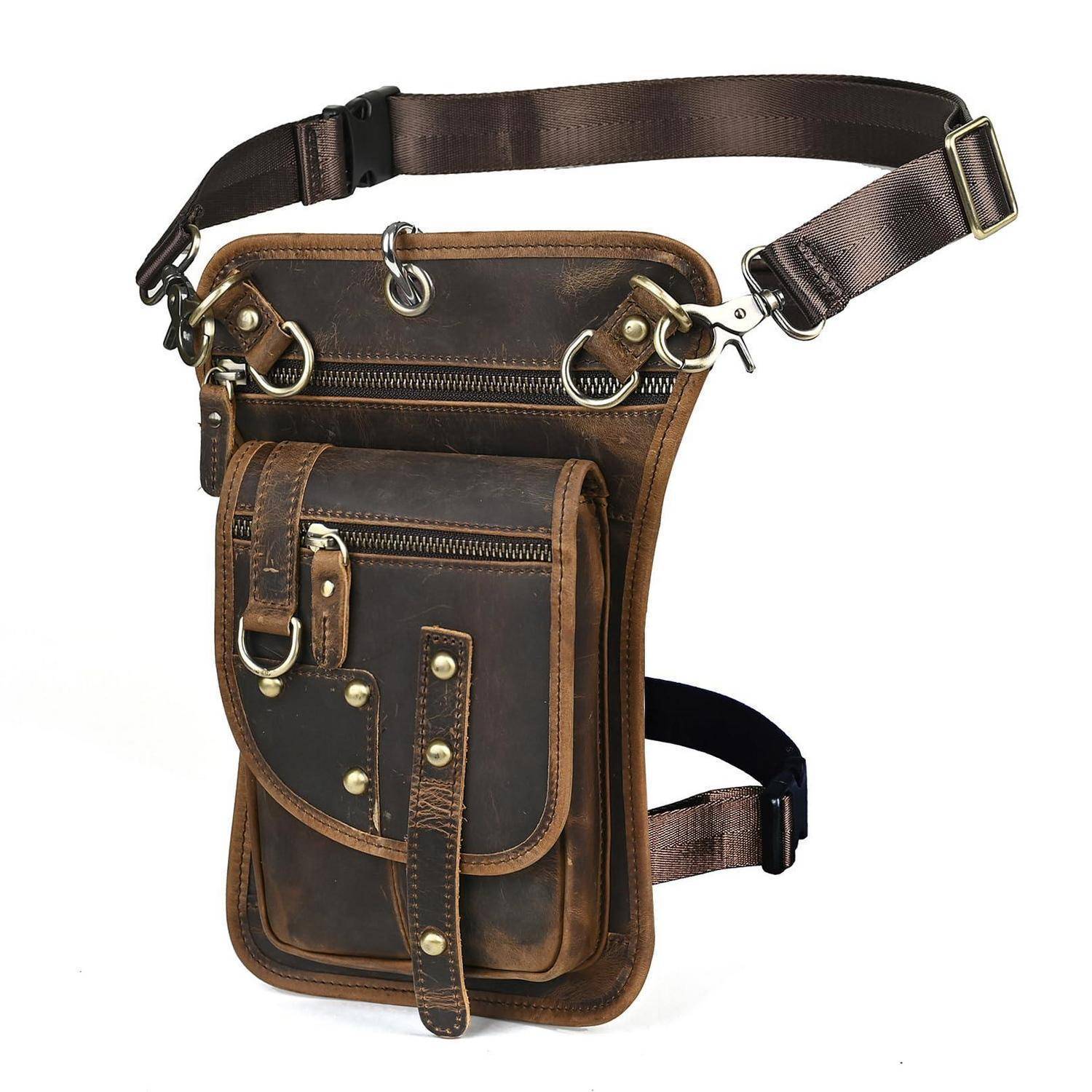 Braune Lederbeinschenkelwerkzeugtasche mit verstellbaren Hüft- und Oberschenkelriemen, mehrere Reißverschluss- und Klapptaschen, auf weißem Hintergrund dargestellt.