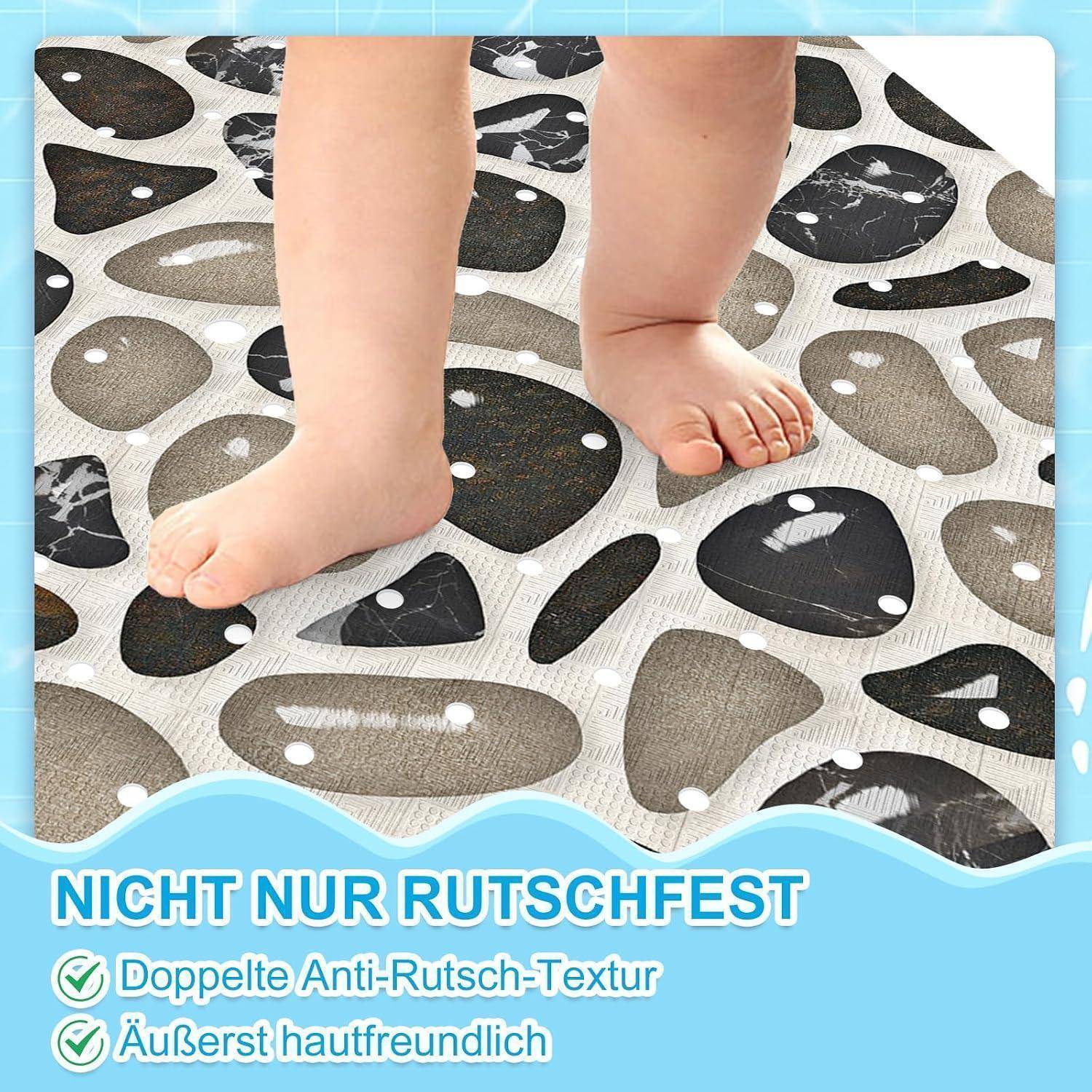 Babyfüße stehen auf einer gemusterten rutschfesten Matte mit deutschem Text: 'NICHT NUR RUTSCHFEST', 'Doppelte Anti-Rutsch-Textur', 'Äußerst hautfreundlich'.