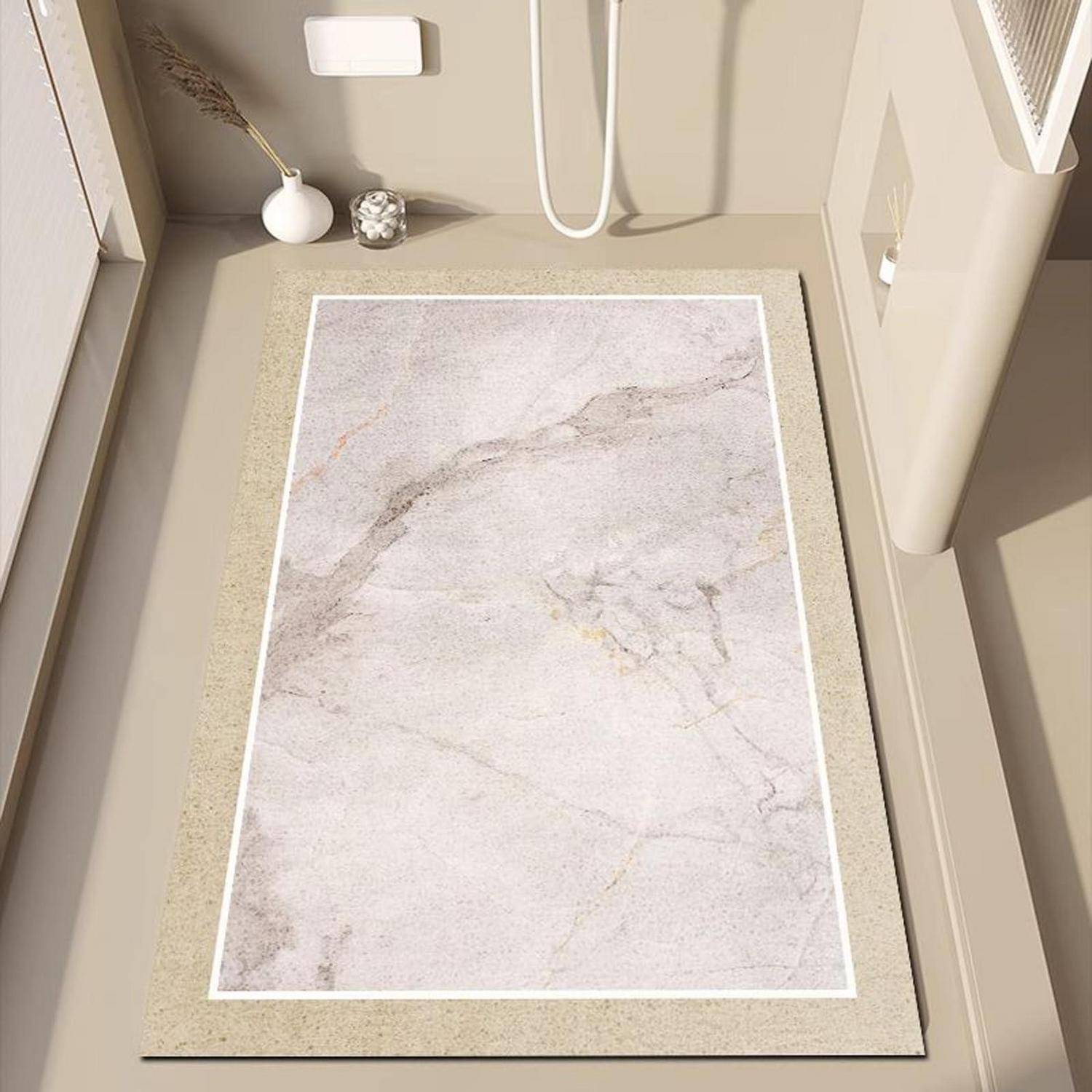 Beige Badematte mit weißem Marmormuster auf einem gefliesten Boden neben einer Toilette und einem Waschbecken.