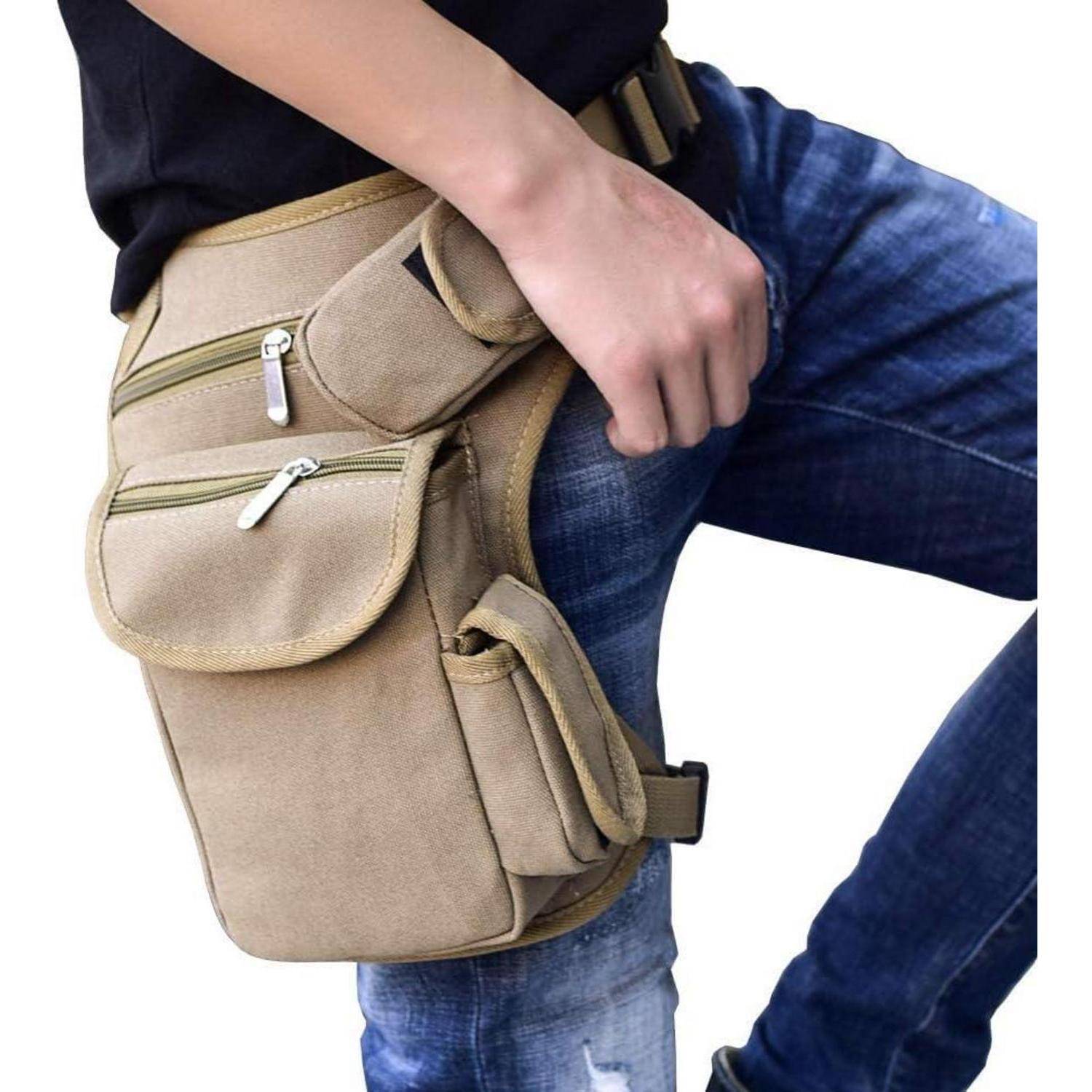 Person, der über einer Jeans eine beige Leinwein-Oberschenkeltasche trägt, die am Oberschenkel befestigt ist und mehrere Reißverschlusstaschen hat.