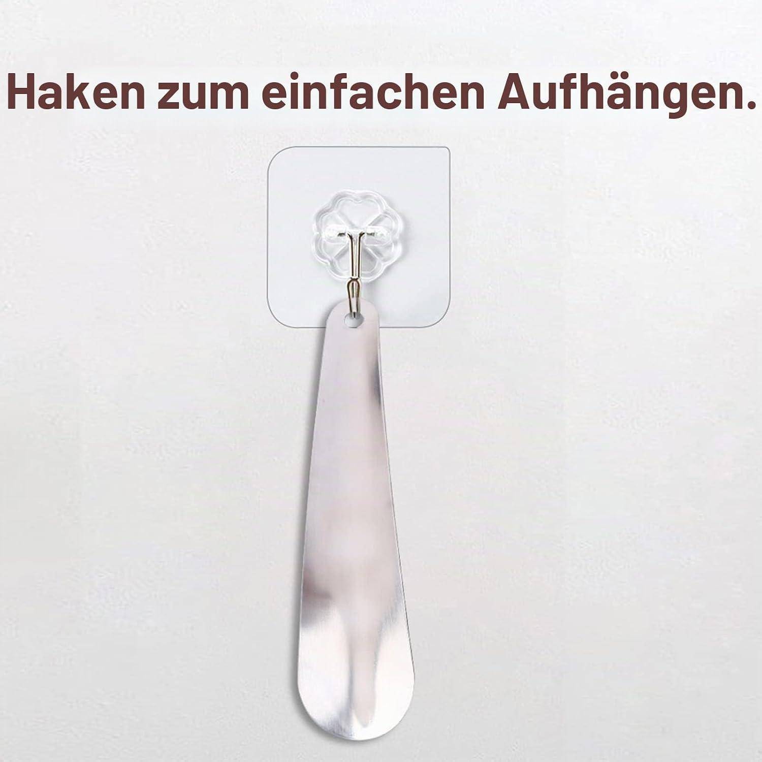 Spiegelhaken an der Wand montiert mit dem Text „Haken zum einfachen Aufhängen." darüber.