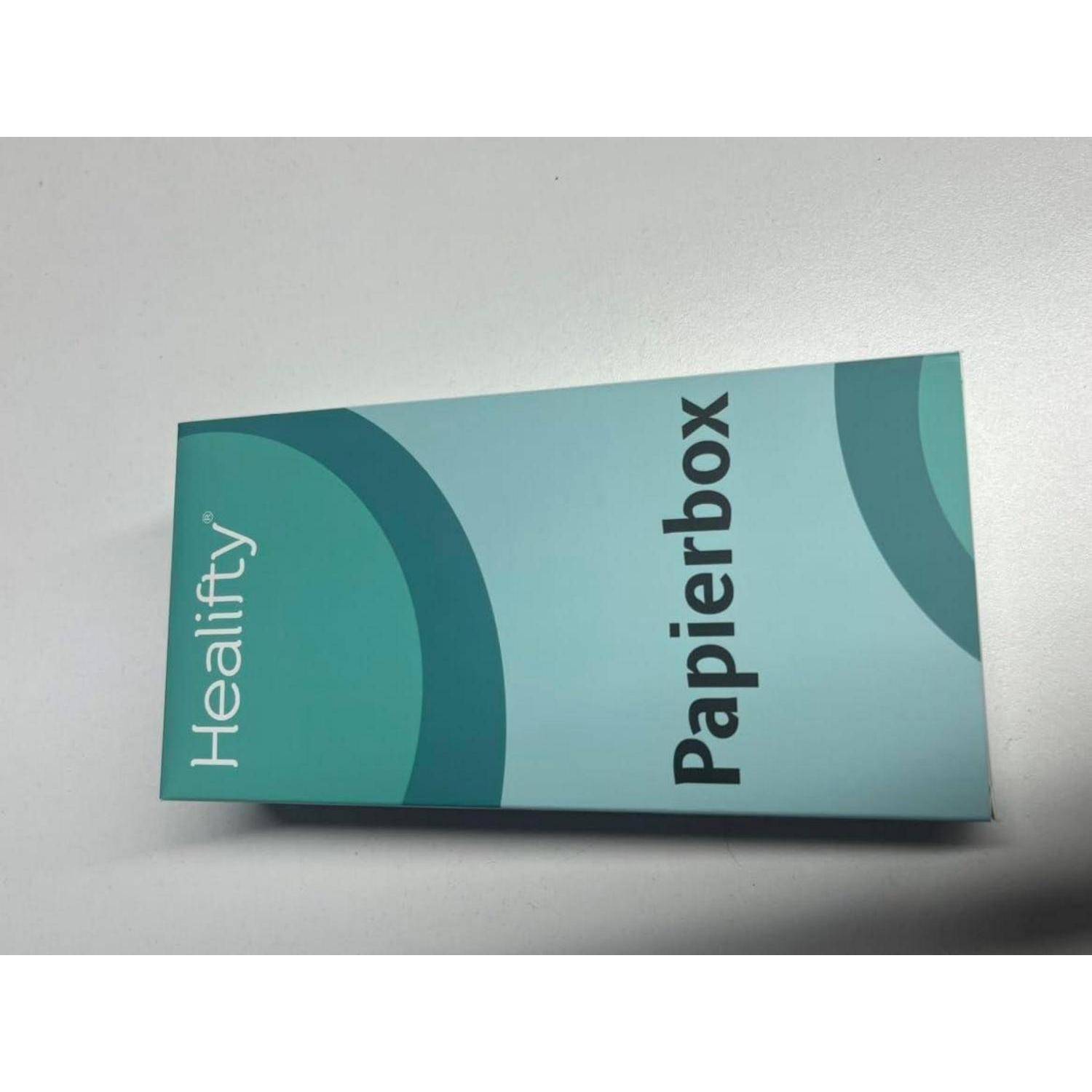 Ein Paket oder eine Box der Marke "Hearthly Papierbox"" in Blaugrün und Hellblau, das auf einer weißen Oberfläche liegt.