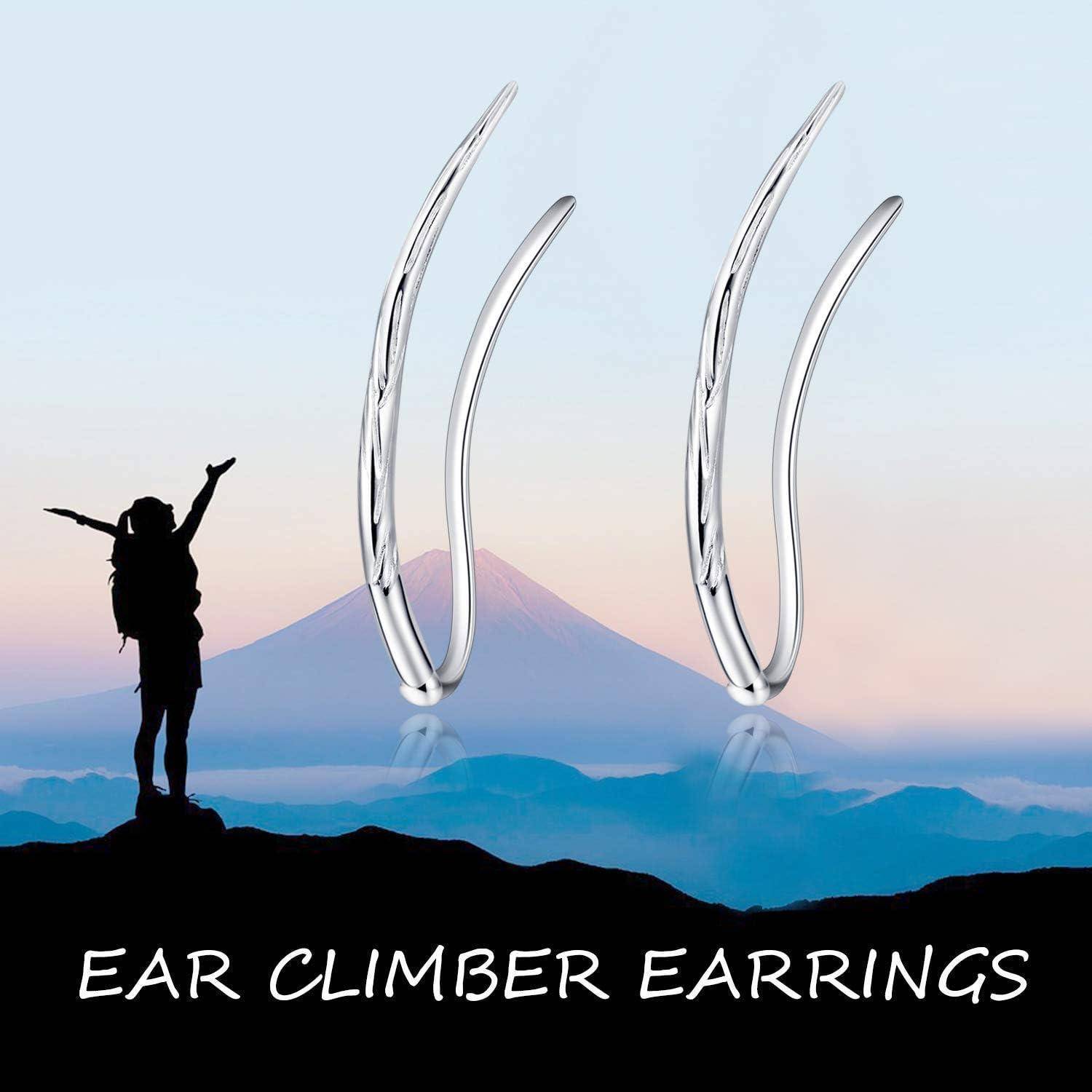 Werbebild von silbernen Ohrkrabbel-Ohrringen über einem Bergsonnenaufgang, mit einer silhouettierten Wanderin und dem Text „EAR CLIMBER EARRINGS