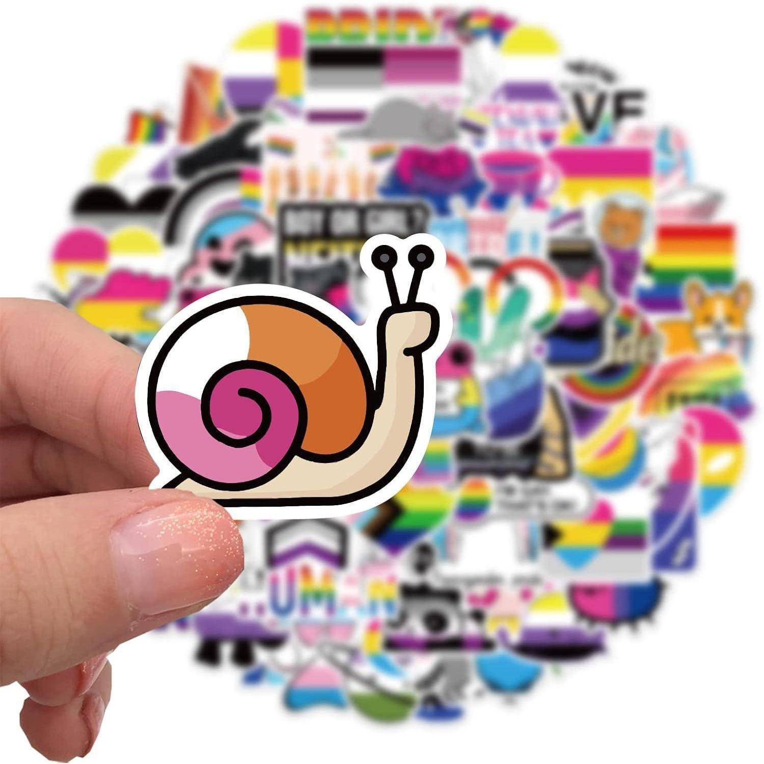 Eine Hand hält einen Cartoon-Schnecken-Aufkleber vor einer Collage aus bunten Pride-Aufklebern und Symbolen.