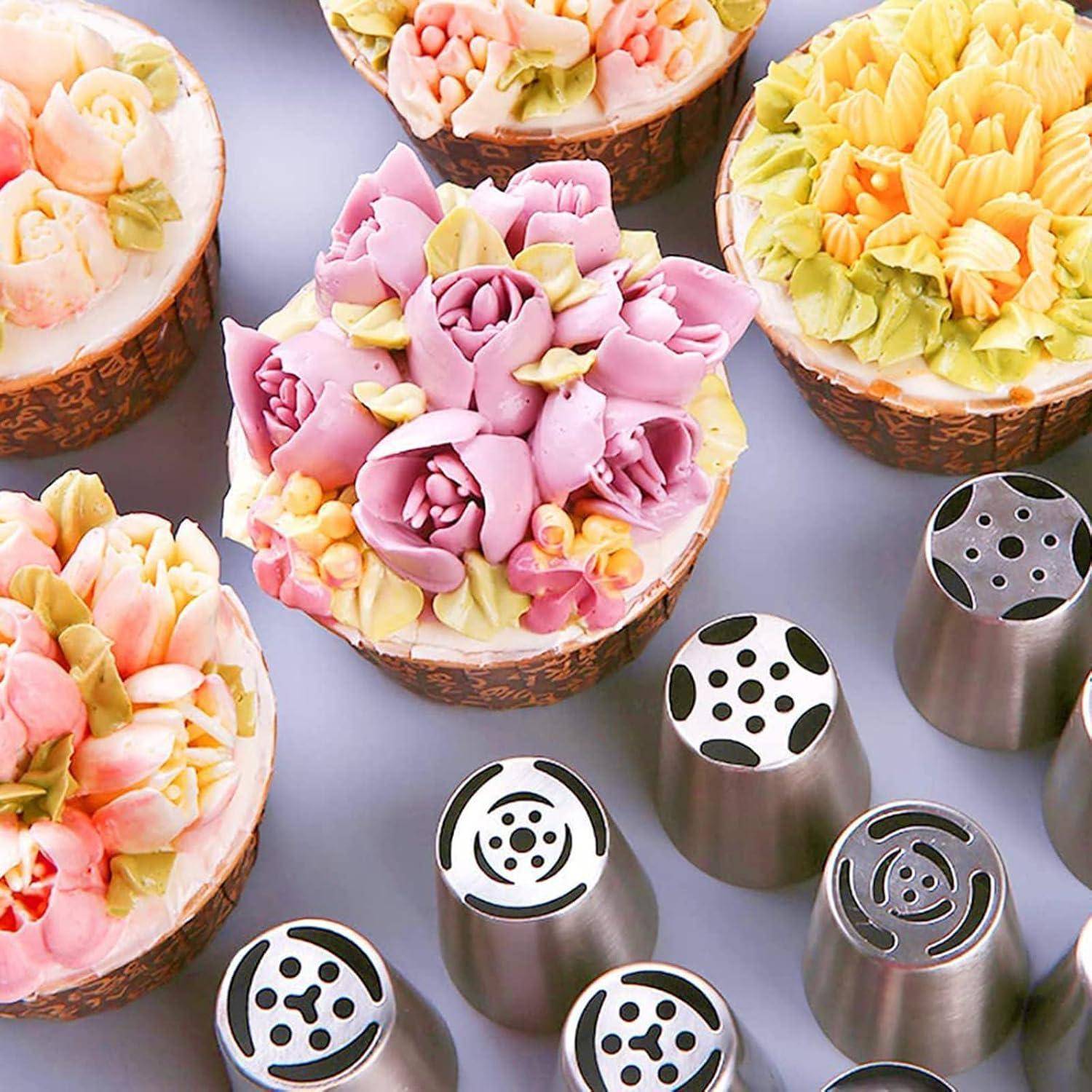 Sortierte blumenförmige glasierte Cupcakes in Körben, mit Metallspritzbeuteltüllen darunter zum Verzieren von Kuchen.