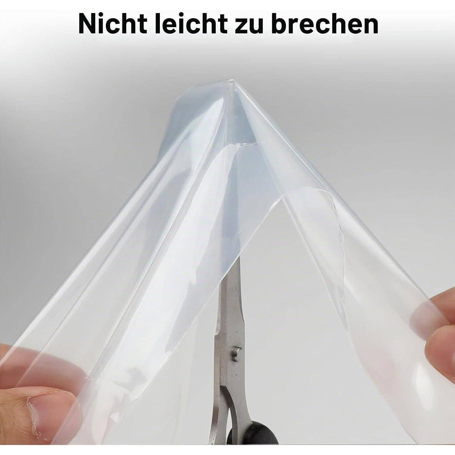 Durchsichtige Schutzfolie über einer Schere gespannt mit deutschem Text 