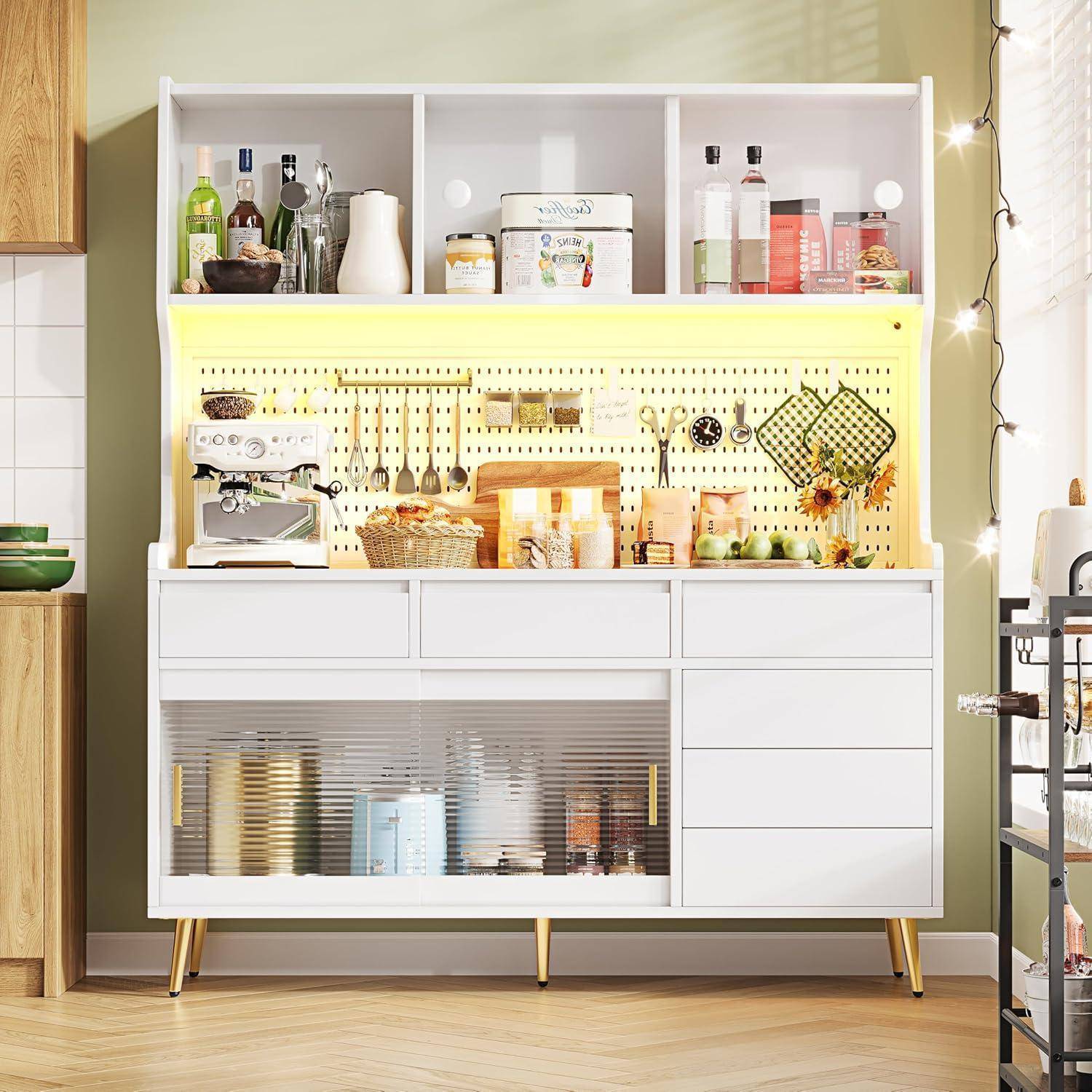 Moderner weißer Lagerschrank mit offenen Regalen, Lochbrett-Rückwand, Kaffeemaschine, Flaschen, Gläsern, Körben und Schubladen in einem hellen Küchen- oder Speisekammerbereich.