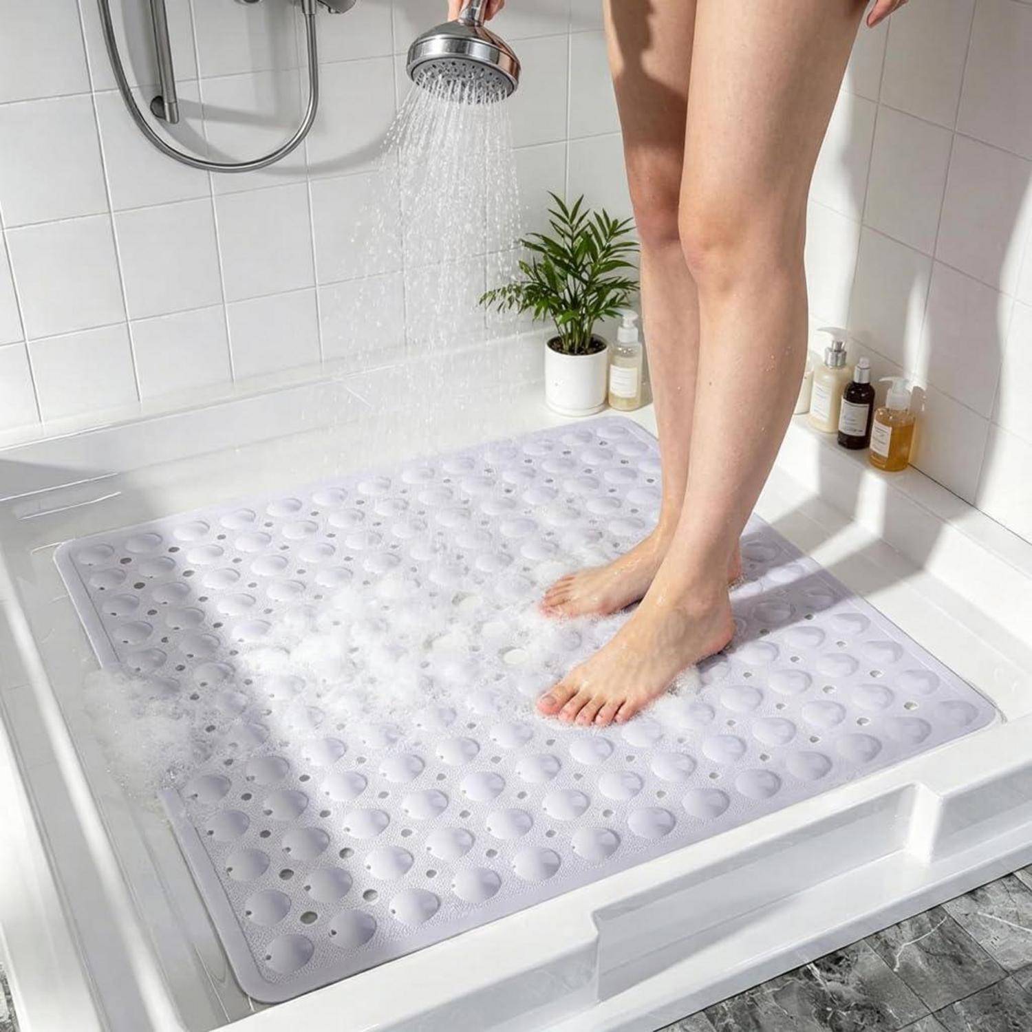 Eine Person steht in einer Dusche auf einer Badematte mit Saugnäpfen, während Wasser fließt, was eine rutschfeste Badezimmerbodenbeschichtung zeigt.