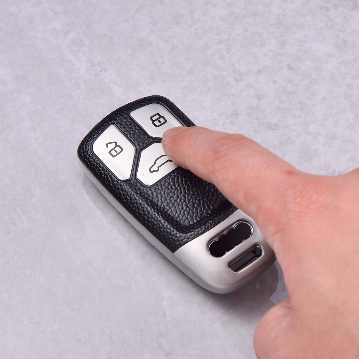 Nahaufnahme einer Hand, die auf die Sperrtaste einer Autoschlüsselfernbedienung mit Sperr-, Entsperr- und Kofferraumsymbolen drückt.