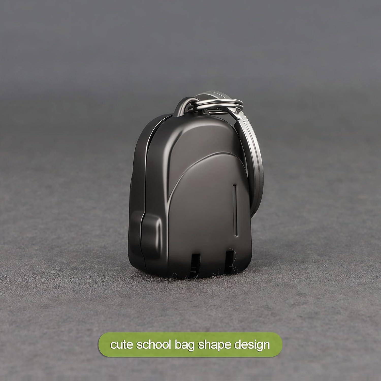 Kleiner schwarzer Schlüsselanhänger in Form eines Schulrucksacks, gezeigt vor einem grauen Hintergrund mit der Beschriftung „niedliches Design in Schulrucksackform