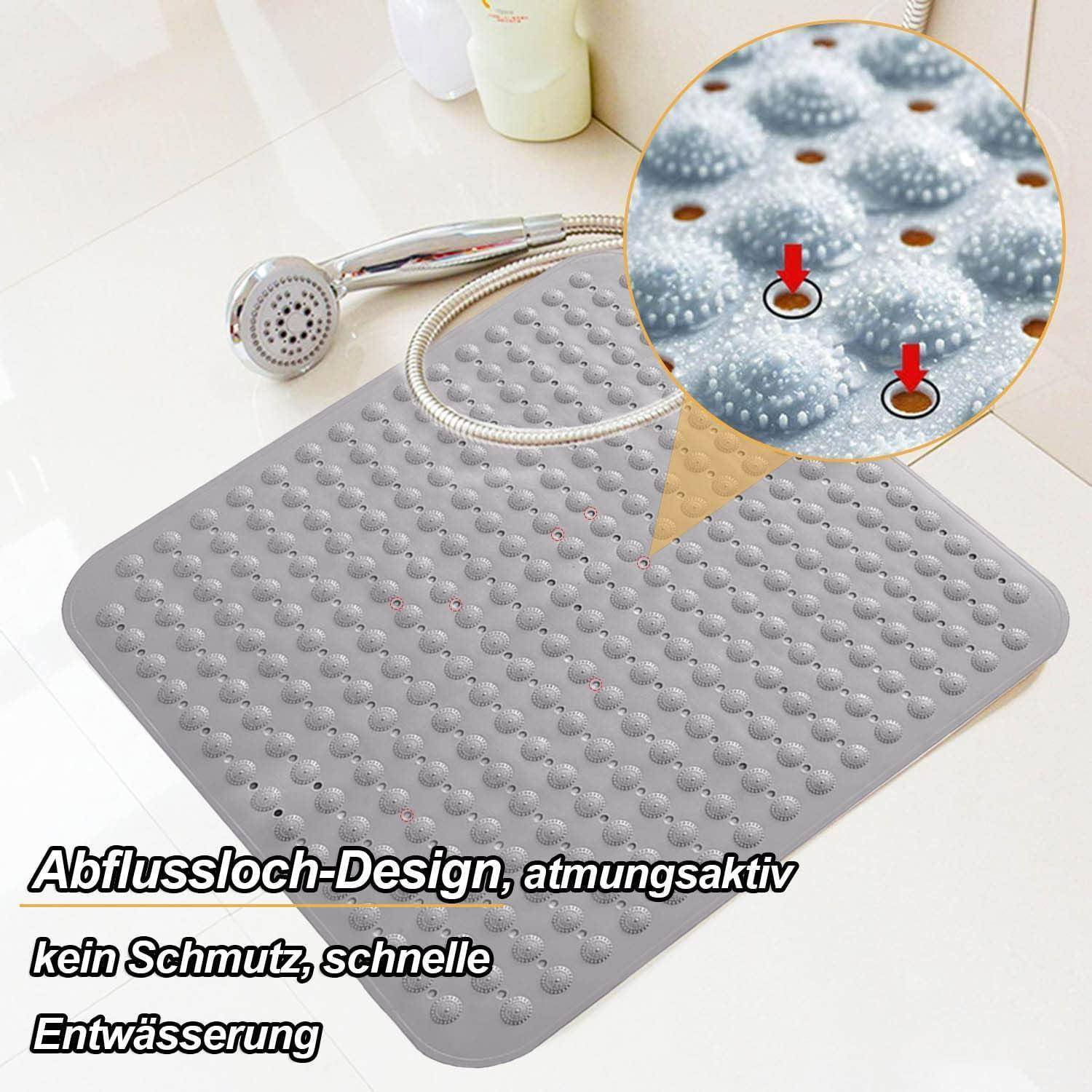 Graue Duscheinlage mit erhabenen Saugnapfpunkten und Ablöchern, gezeigt mit Handbrause und vergrößerter Detailansicht, die das rutschfeste, schnell ableitende Design hervorhebt.