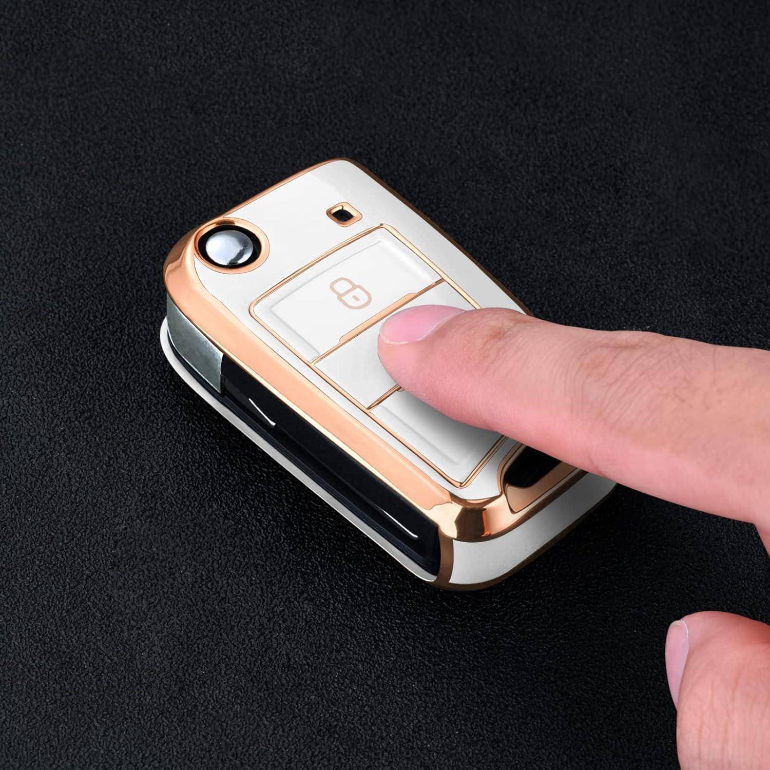 Finger drückt einen Knopf auf einem goldenen Autoschlüsselteil vor einem dunklen Hintergrund.