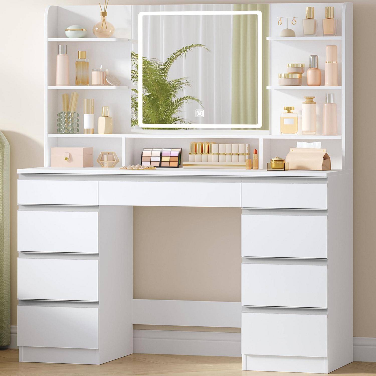 Weißer Schminktisch mit Spiegel und eingebauten Regalen, ordentlich angeordnet mit Kosmetikflaschen, Gläsern und Make-up-Organisern.