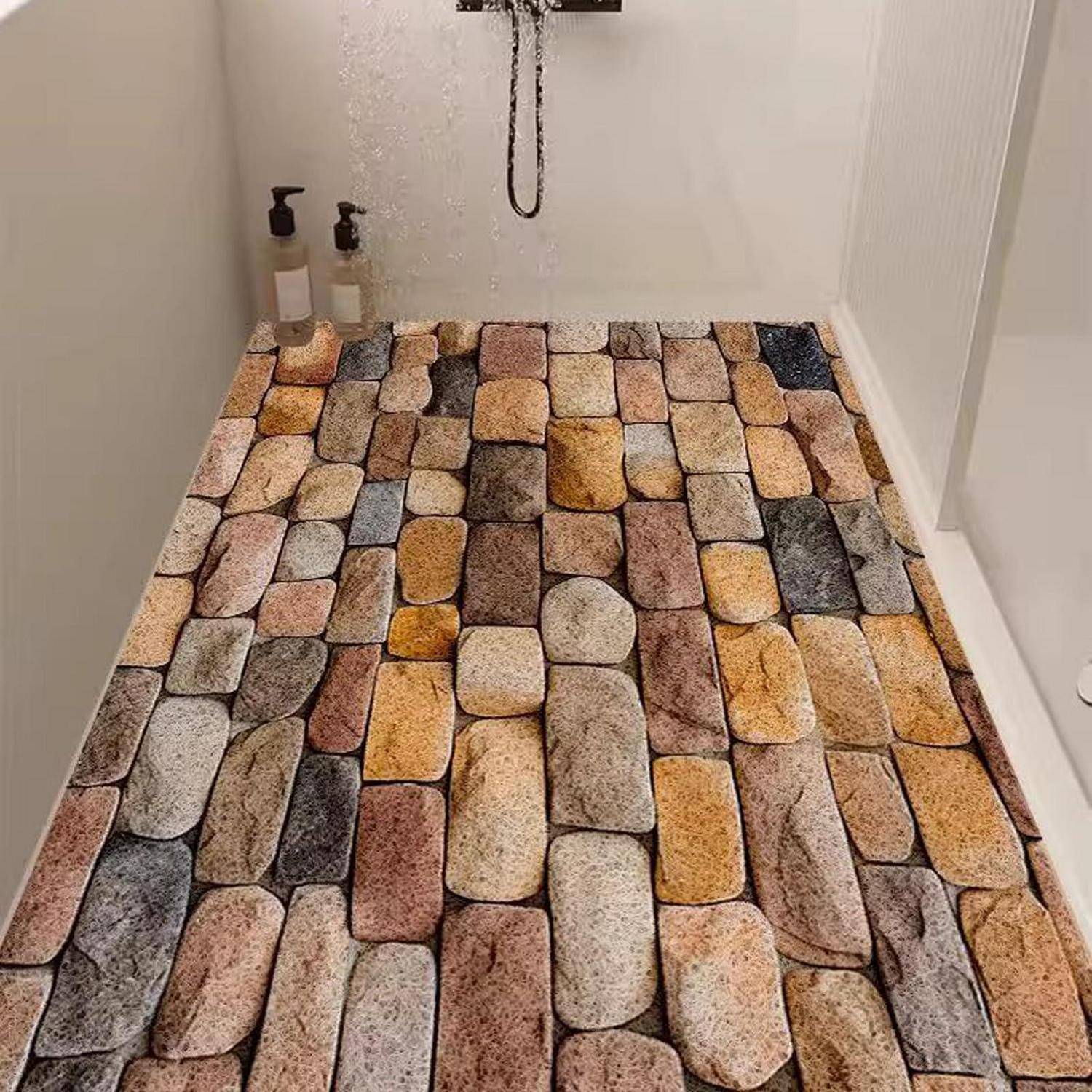 Duschtasse mit mehrfarbigen Steinplatten ausgelegt, mit zwei Seifenspendern auf dem Sims hinten.