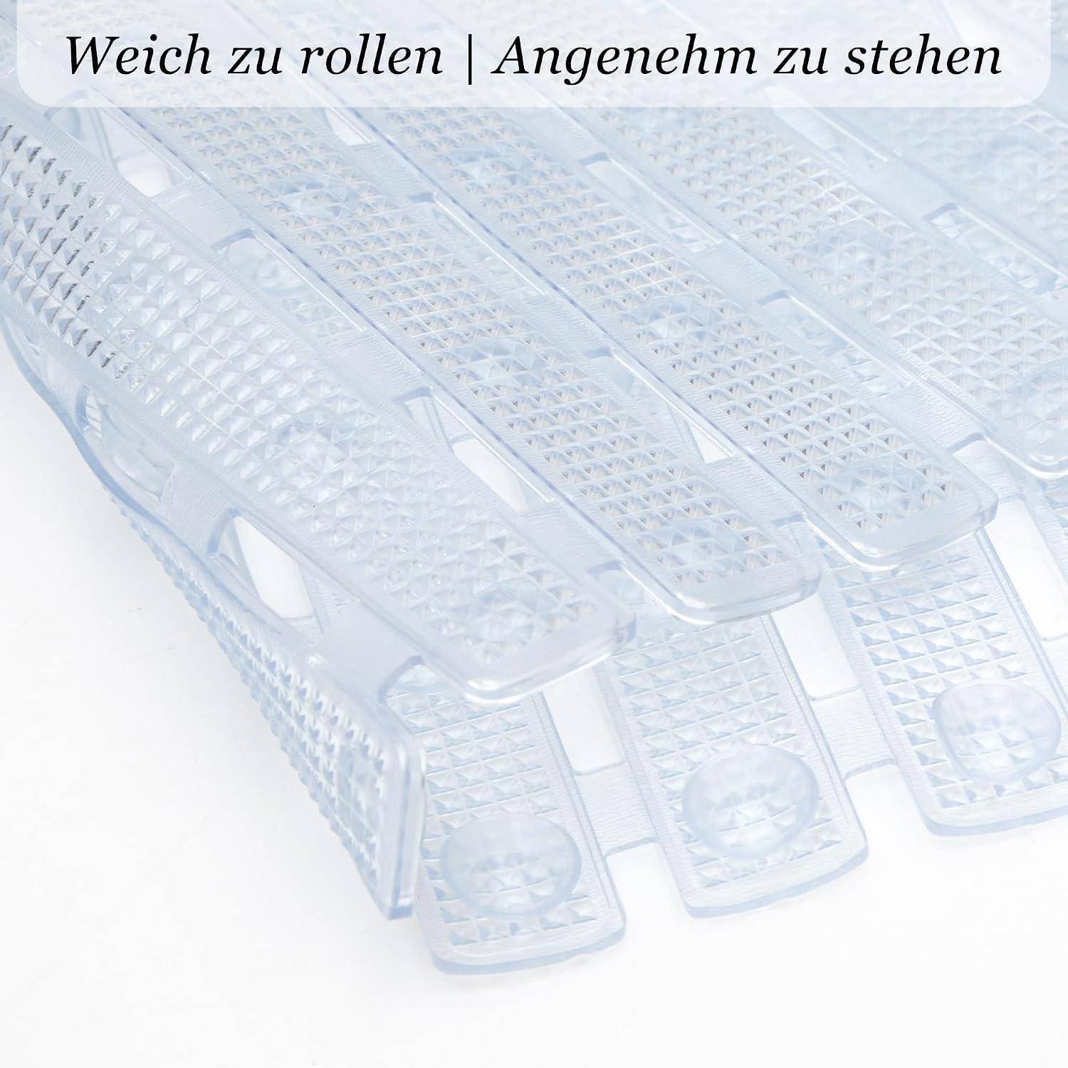 Durchsichtige Kunststoff-Fersengriffe mit strukturierter Oberfläche; Text lautet „Weich zu rollen | Angenehm zu stehen".