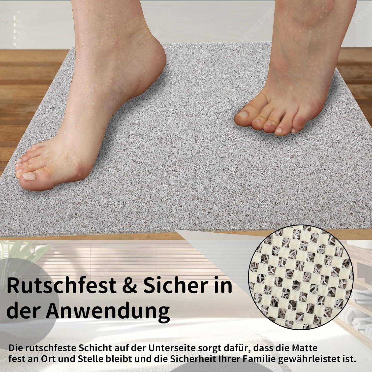 Füße stehen auf einer grauen rutschfesten Matte, mit deutschem Text, der besagt „Rutschfest & Sicher in der Anwendung" und erklärt, dass die Unterseite die Matte sicher an Ort und Stelle hält.
