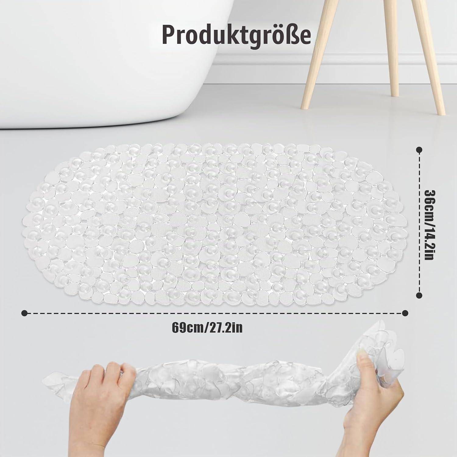 Produktgrößenbild einer durchsichtigen ovalen Badematte, die 69 cm x 36 cm misst, mit Händen, die ihre flexible gerollte Form zeigen.