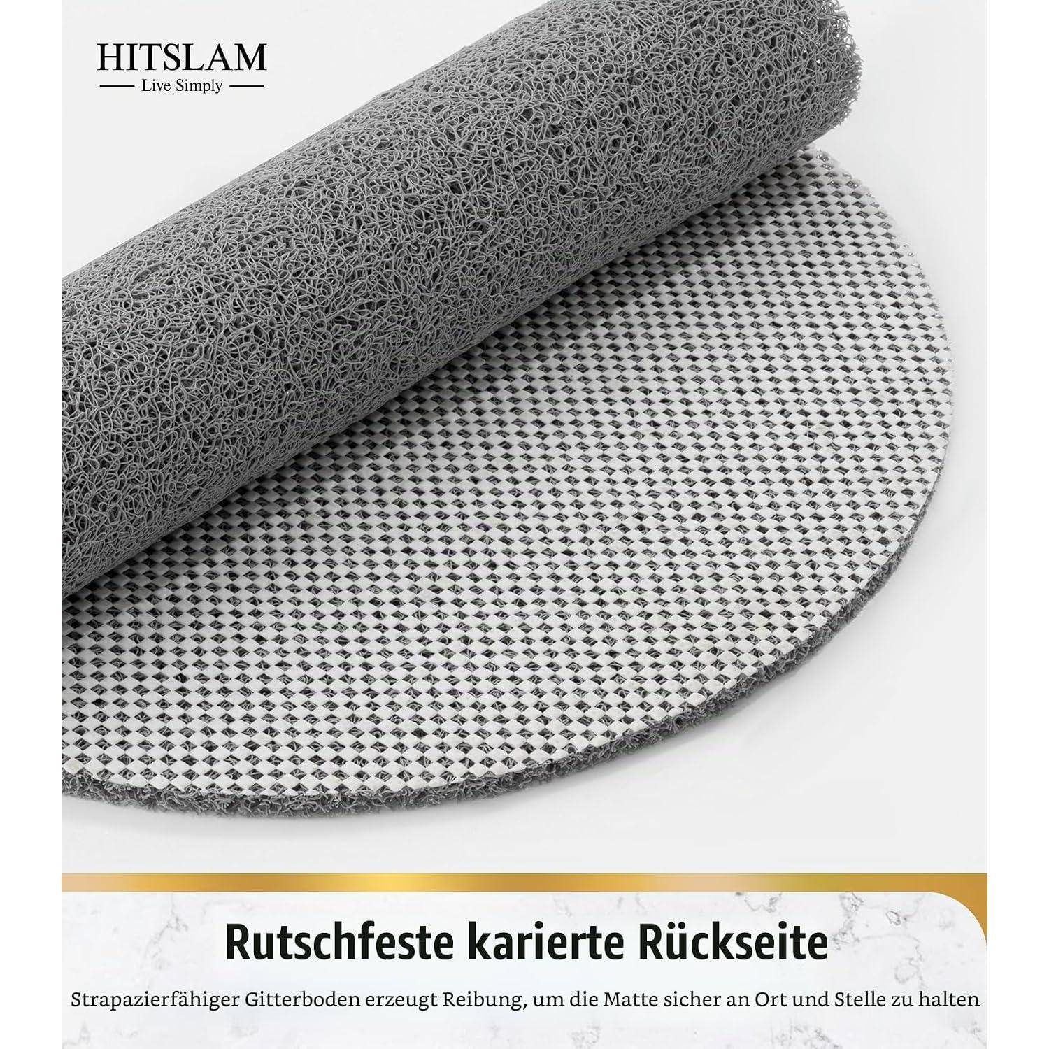 Gerollte graue rutschfeste Matte mit strukturierter Oberfläche und karierter Rückseite; Der deutsche Text besagt „Rutschfeste karierte Rückseite" für Griffigkeit und Stabilität.