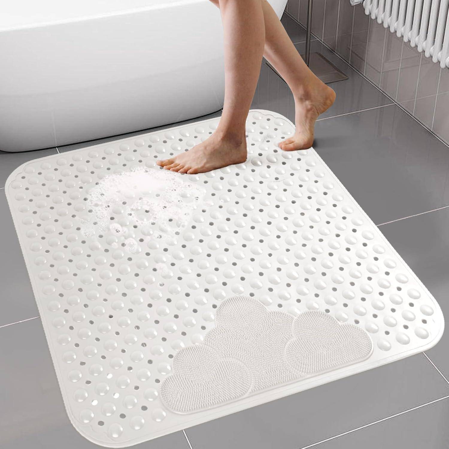 Person, die auf einer weißen strukturierten Badmatte neben einer Badewanne in einem gekachelten Badezimmer steht.