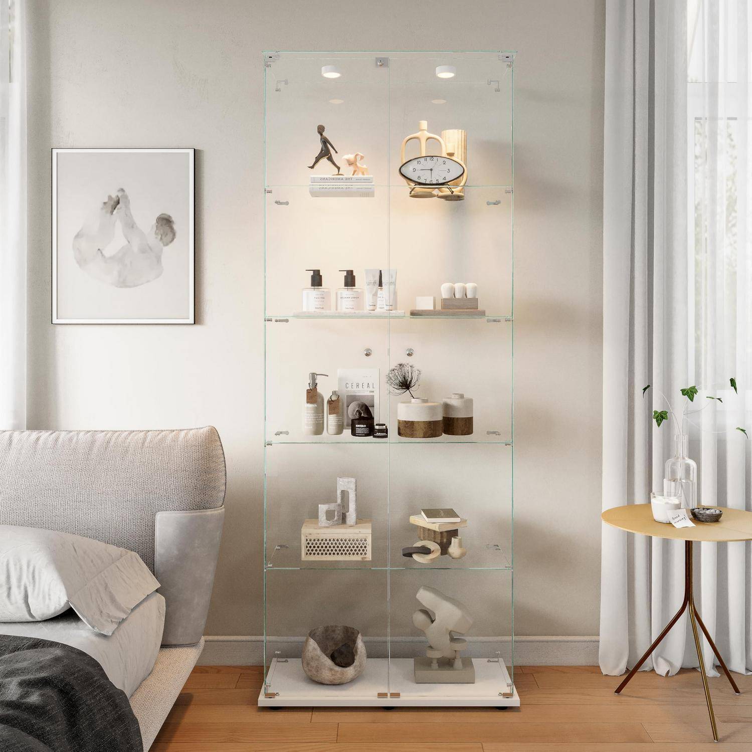 Modernes Wohnzimmer mit einer klaren Glaskabinett zur Produktpräsentation, die Hautpflegeprodukte und Dekorationsgegenstände aufbewahrt, neben einem Sofa und einem kleinen Beistelltisch in der Nähe eines Fensters.