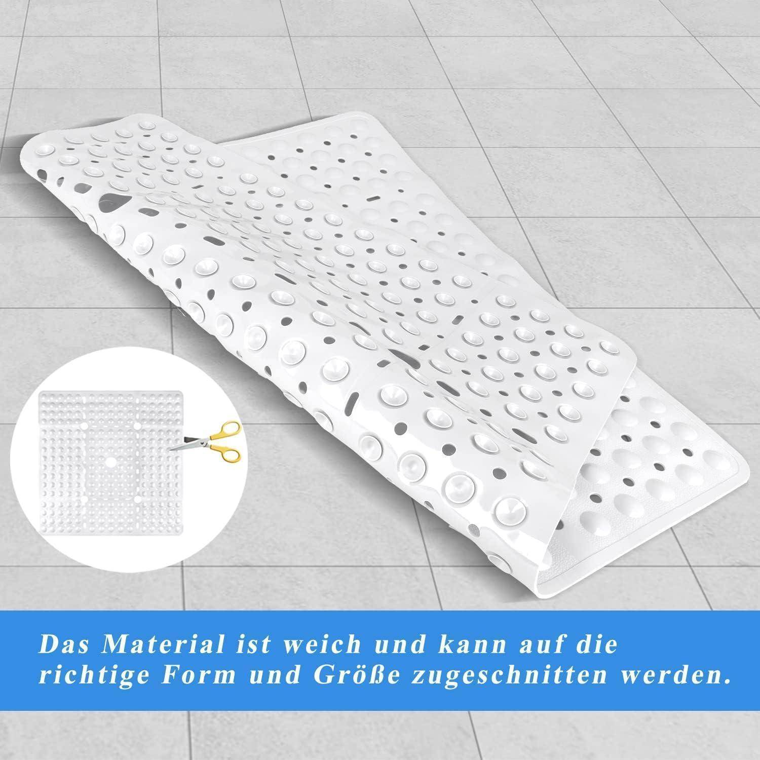 Weiße perforierte Badmatte oder Einlage, gefaltet auf einem gefliesten Boden gezeigt, mit einer Vergrößerung, die zeigt, dass sie zurechtgeschnitten werden kann; deutscher Text besagt, dass das Material weich ist und zum Anpassen zugeschnitten werden kann.