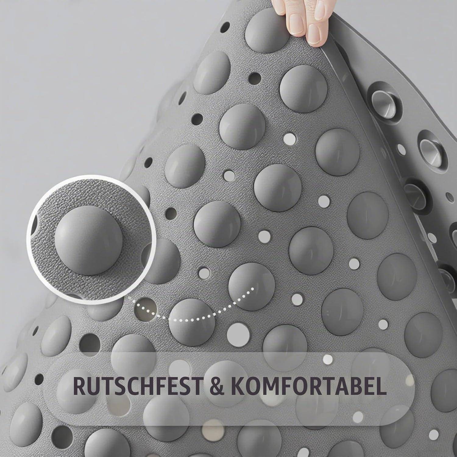 Graue strukturierte rutschfeste Oberfläche mit erhobenen runden Noppen und dem deutschen Text „RUTSCHFEST & KOMFORTABEL